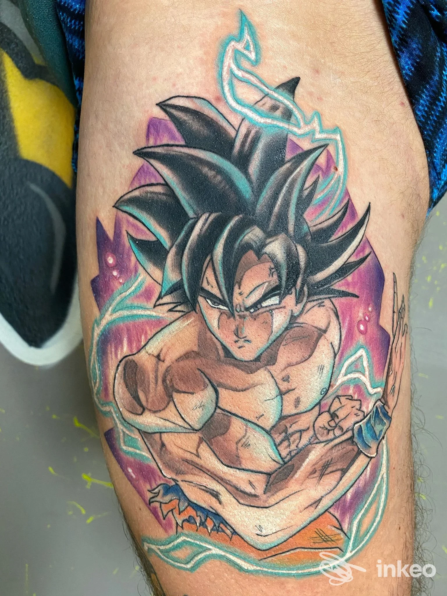 Tatuaggio a colori sull’avambraccio raffigurante Goku in stile anime Dragon Ball, con linee nette e colori vivaci.