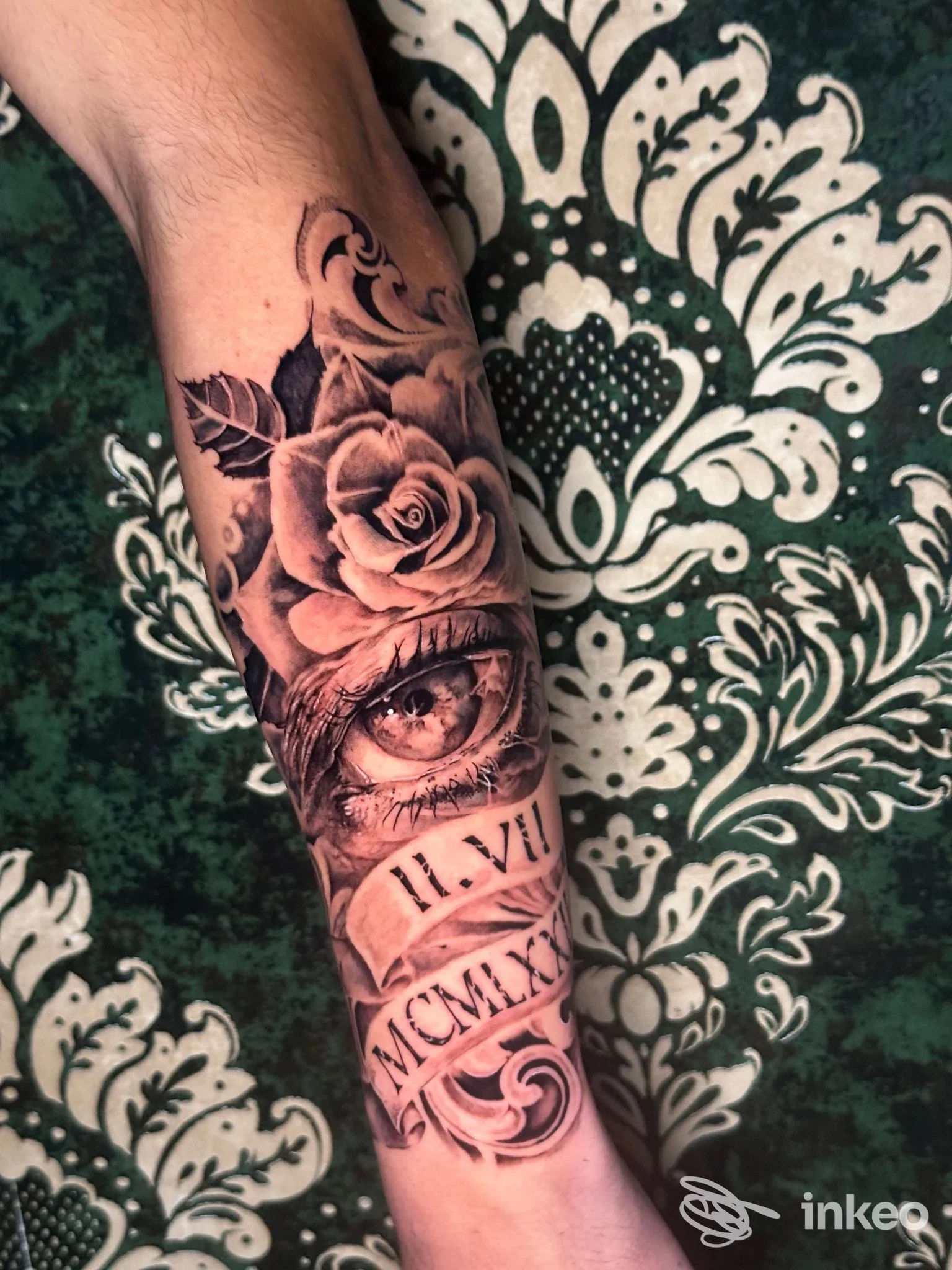 Tatuaggio realistico sul polso raffigurante una rosa, un occhio e numeri romani; realizzato dal Santangelo Tattoo Studio, Sulmona.