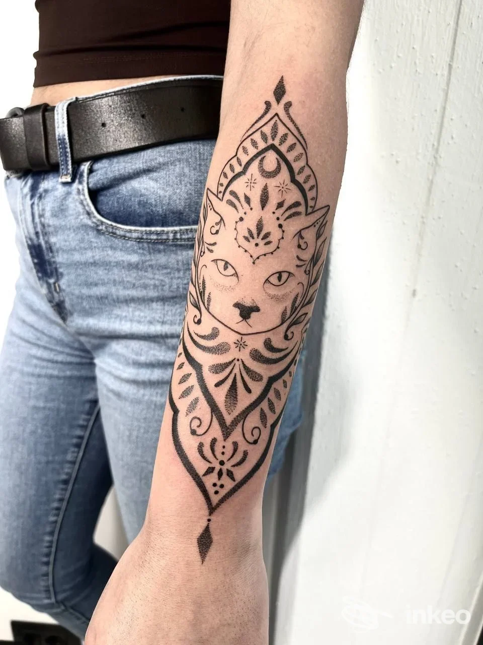 Tatuaggio in stile decorativo con figura di gatto sulla parte interna dell’avambraccio di una persona, eseguito da Aenema Ink Tattoo a Pineto, in Italia.