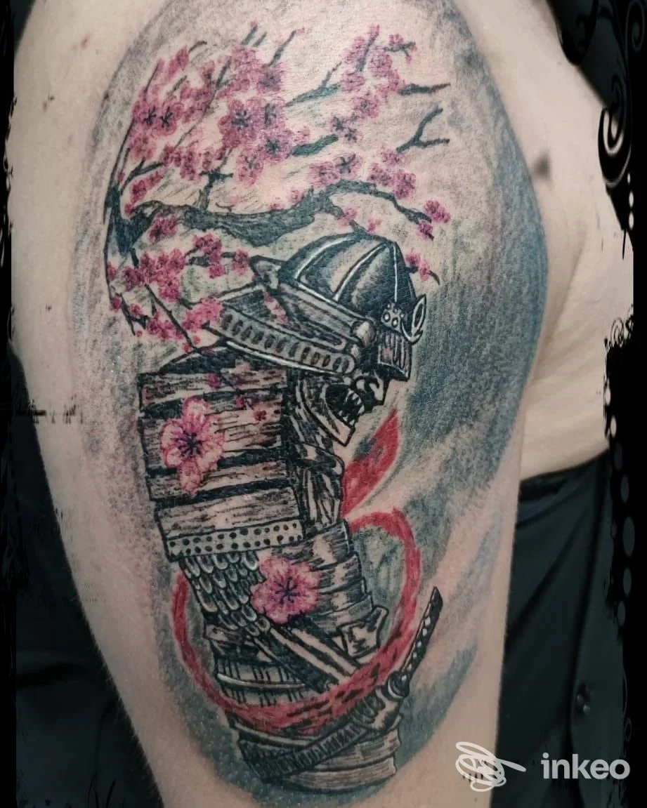 Tattoo completo su braccio raffigurante una figura in armatura samurai con fiori di ciliegio rosa, su sfondo sfumato blu. opera colorata e definita.