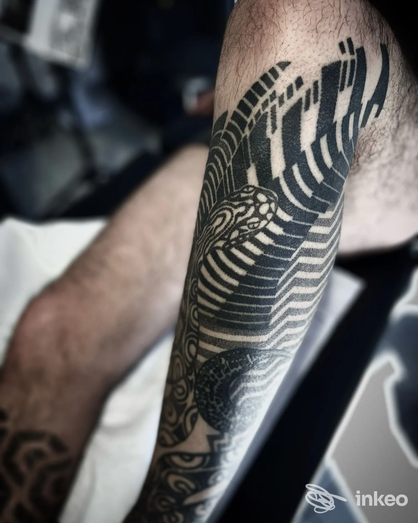 Gamba con tatuaggio in stile geometrico, nero su pelle, scatto fotografico in esterno o interno. Studio Tattoo Club.