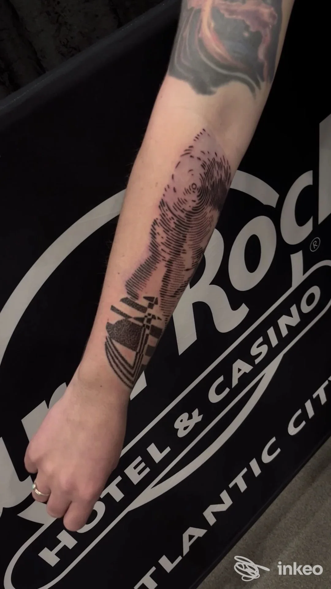 Avambraccio sinistro con tattoo grafico nero di linee e cerchi; nessun volto visibile né elementi di interfaccia social; immagine singola.