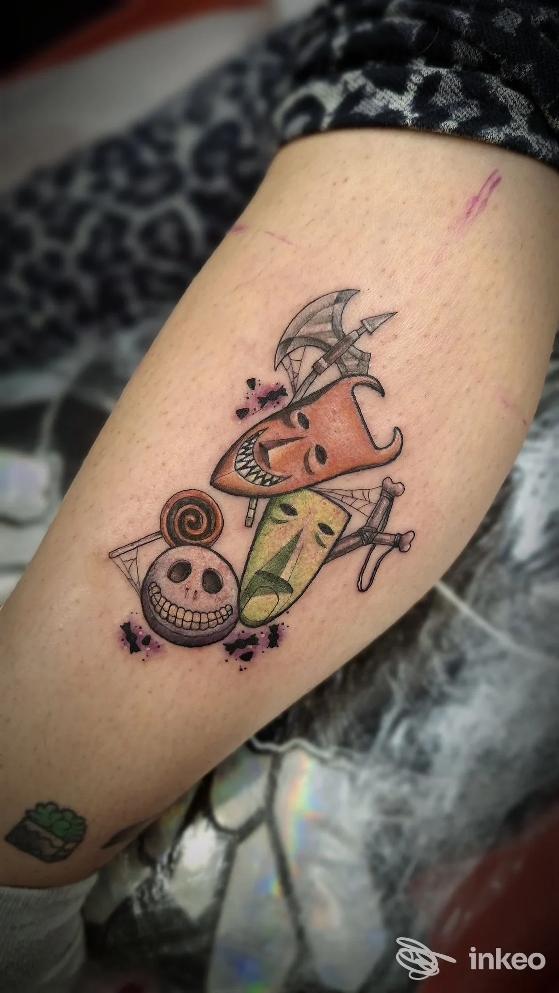 Tatuaggio colorato su avambraccio con tre maschere stilizzate, immagine fornita da 'Til Death - Tattoo Studio, Villanova.