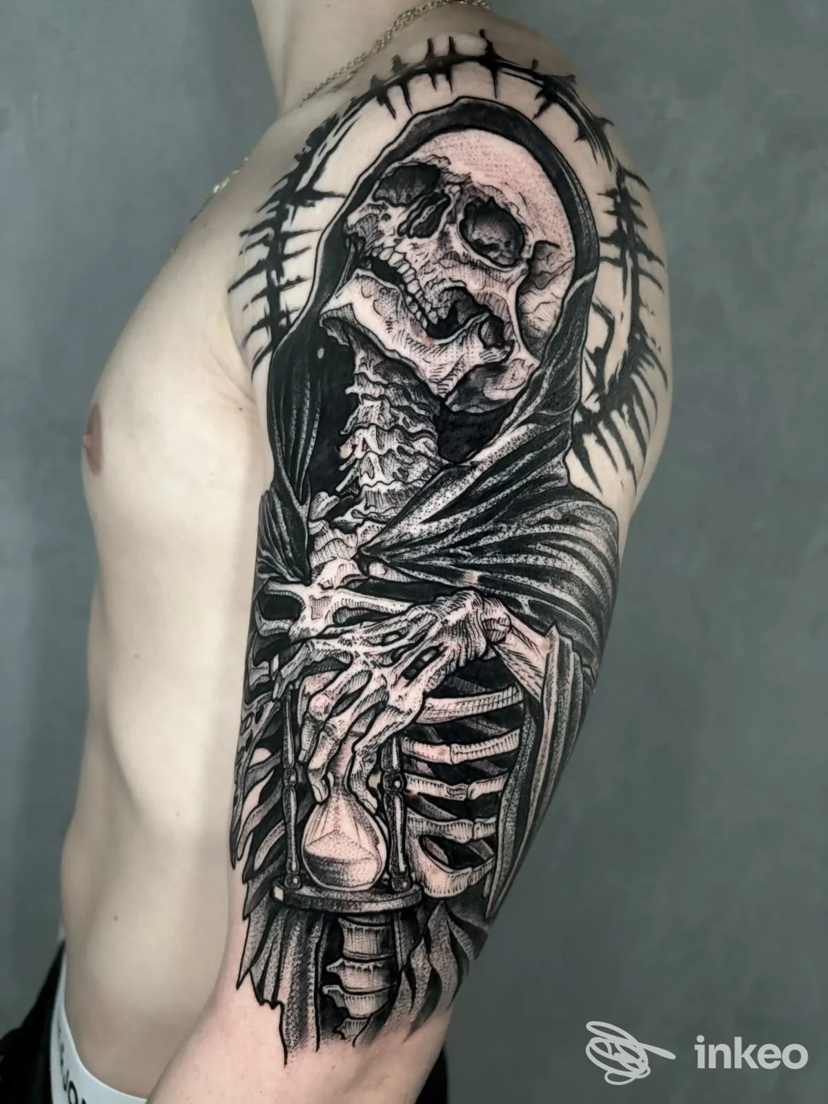 Grande tatuaggio realistico di teschio e scheletro sulla spalla e braccio superiore, realizzato da SelfMade Tattoo a Lemignano.