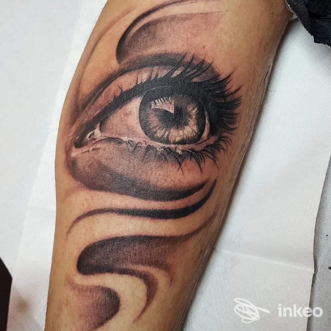 Primo piano di tatuaggio realistico a forma di occhio sull'avambraccio, realizzato da Sorry Mum Tattoo Studio a Novafeltria.
