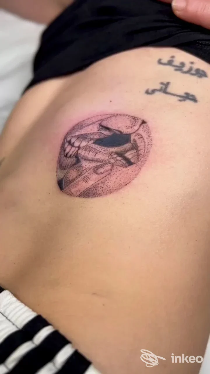 Tatuaggio circolare e scritta in caratteri arabi sul fianco, foto inviata da Facemaster Lash Style & Tattoo Makeup a Riccione.