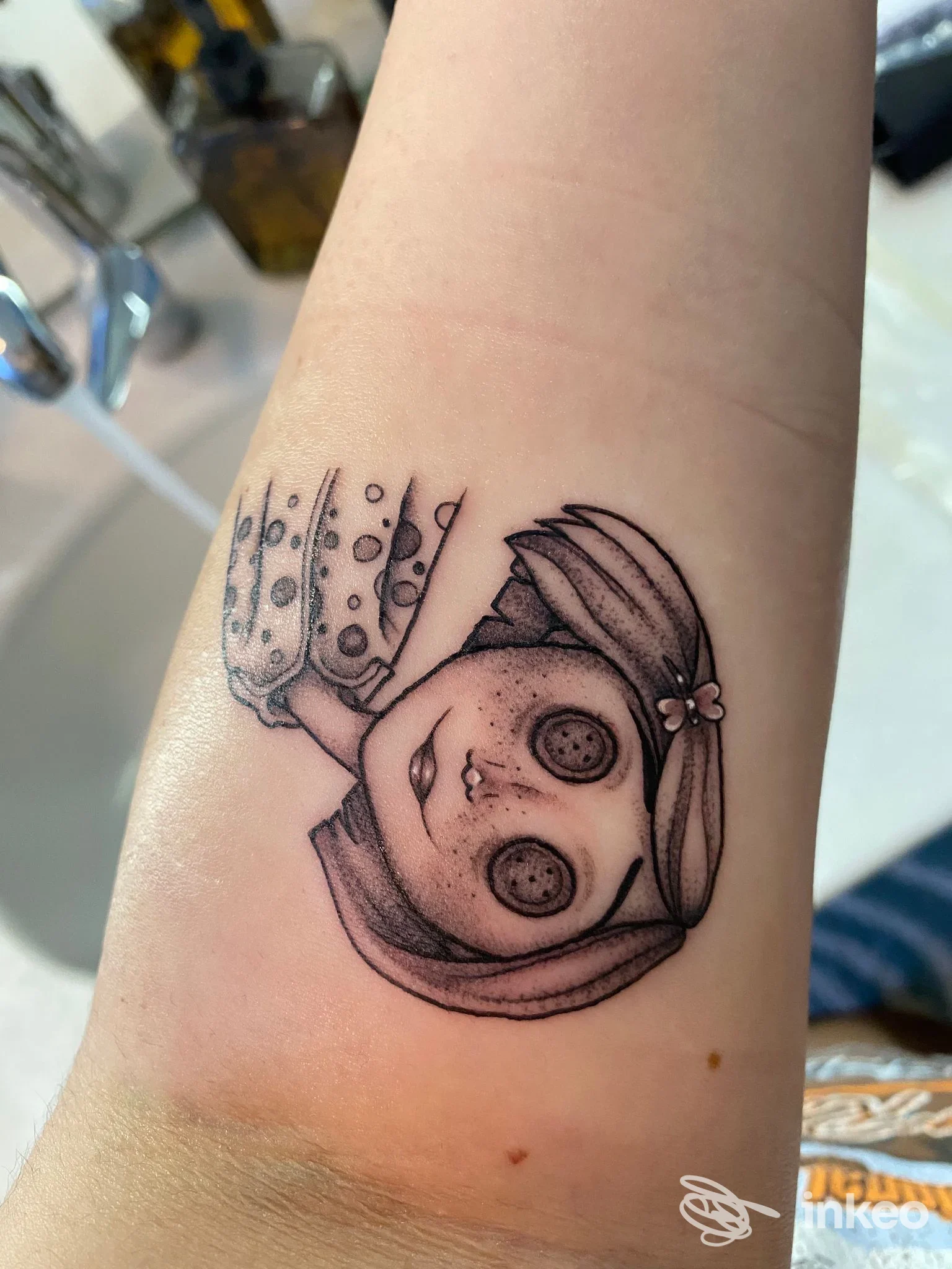 Tatuaggio in bianco e nero di una testa stilizzata su avambraccio, foto fornita da All Ink Tattoo Forlì, Forlì.