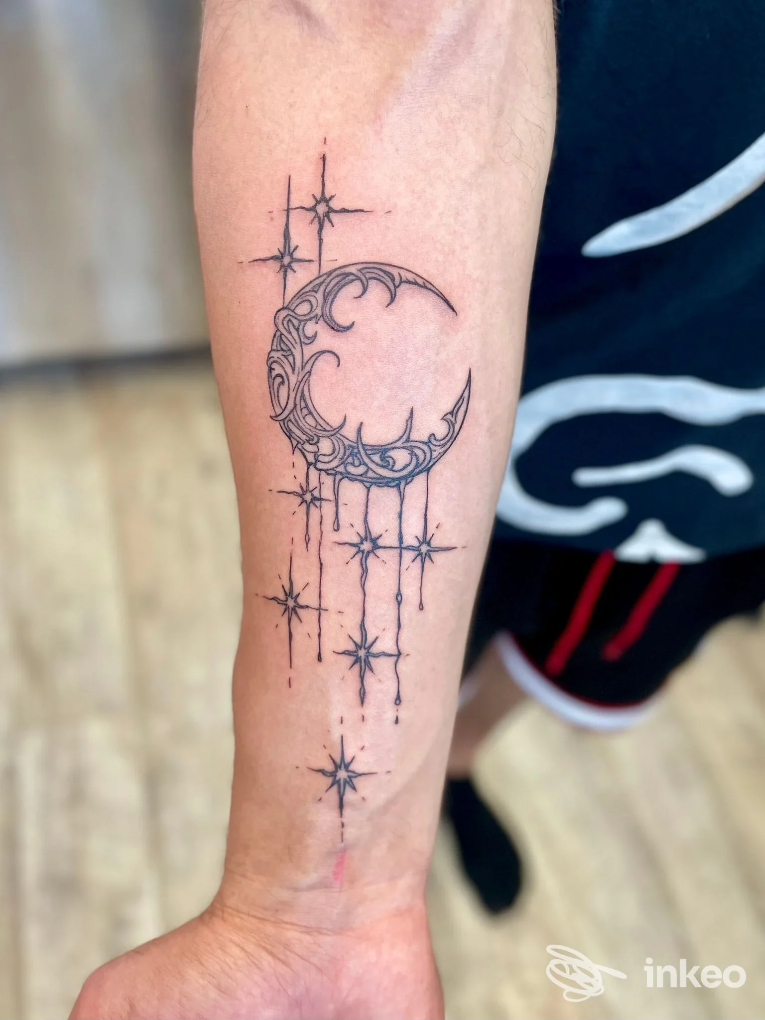 Tatuaggio mezzaluna decorata con stelle sull'avambraccio, realizzato da Lagoon Ink a Marano Lagunare.