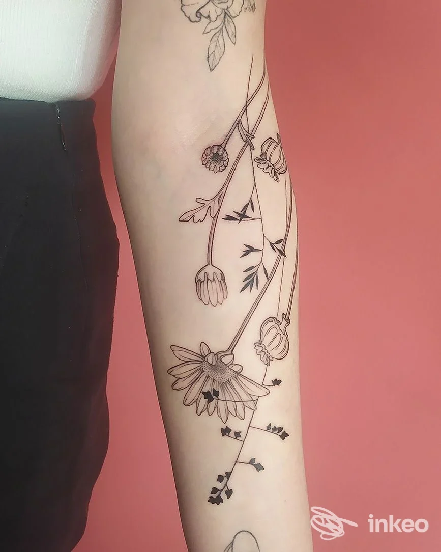 Tatuaggio floreale a linee sottili sull'avambraccio, fotografia di Millantare Tattoo a Udine.