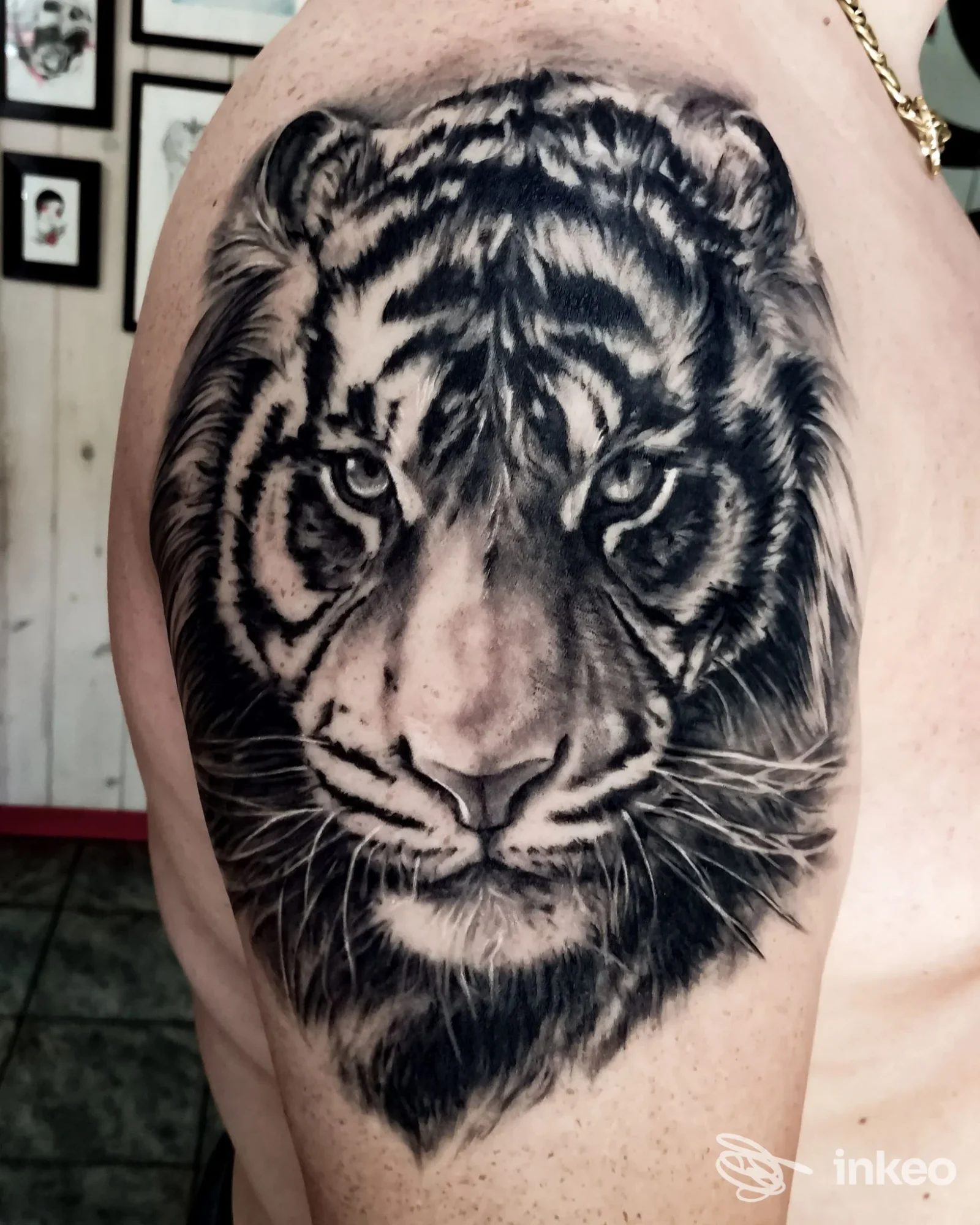 Grande tatuaggio realistico in bianco e nero di una testa di tigre sulla spalla/braccio superiore, fotografato nello studio Soul Trip Tattoo a Roma.