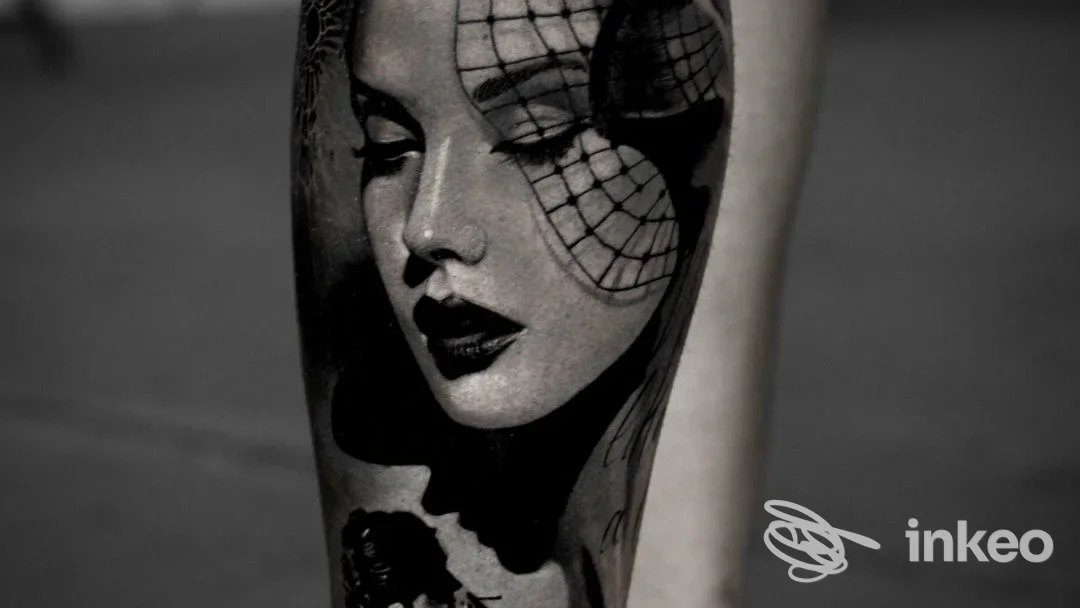 Tatuaggio realistico in bianco e nero raffigurante un volto femminile sul polpaccio, Studio di tatuaggi e Piercing Roma - Artifact Studios, Roma.