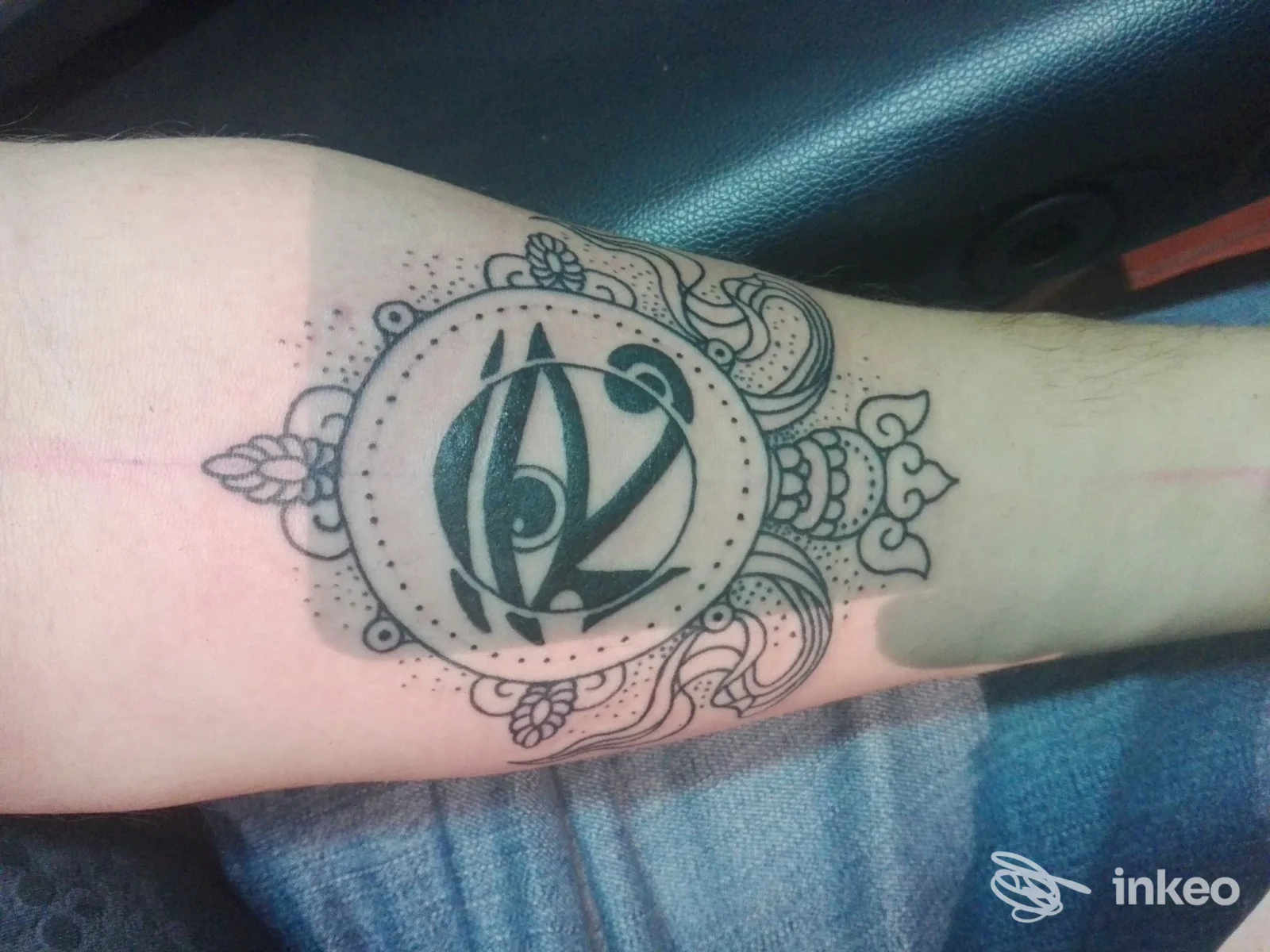 Tatuaggio circolare nero con motivi ornamentali sull'avambraccio, realizzato da White Fang Tattoo a Roma.