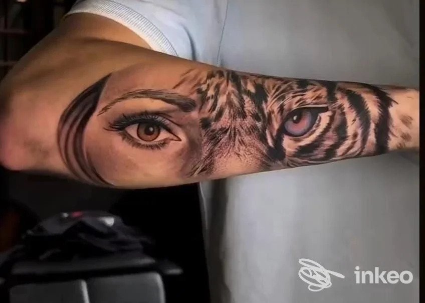 Tatuaggio realistico su avambraccio con occhio umano e occhio di tigre, foto fornita da Duman Tattoo Studio, Genova.