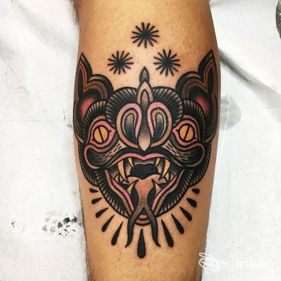 Tatuaggio neo-traditional di una maschera colorata sull'avambraccio, foto fornita da Hari Onago Tattoo Studio, La Spezia.