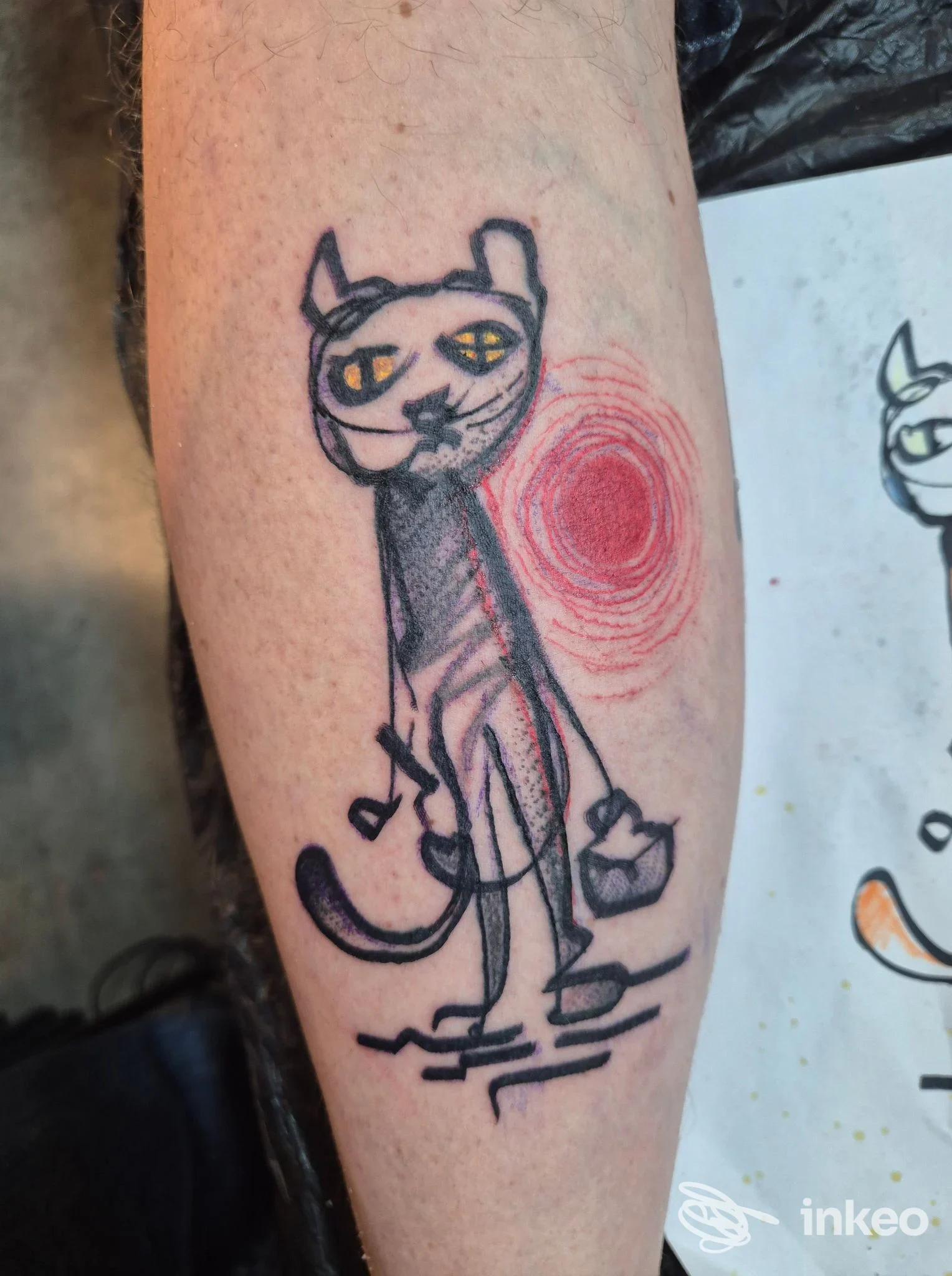 Tatuaggio sul polso/avambraccio raffigurante un gatto stilizzato con dettaglio rosso, Morotattoo, Genova.