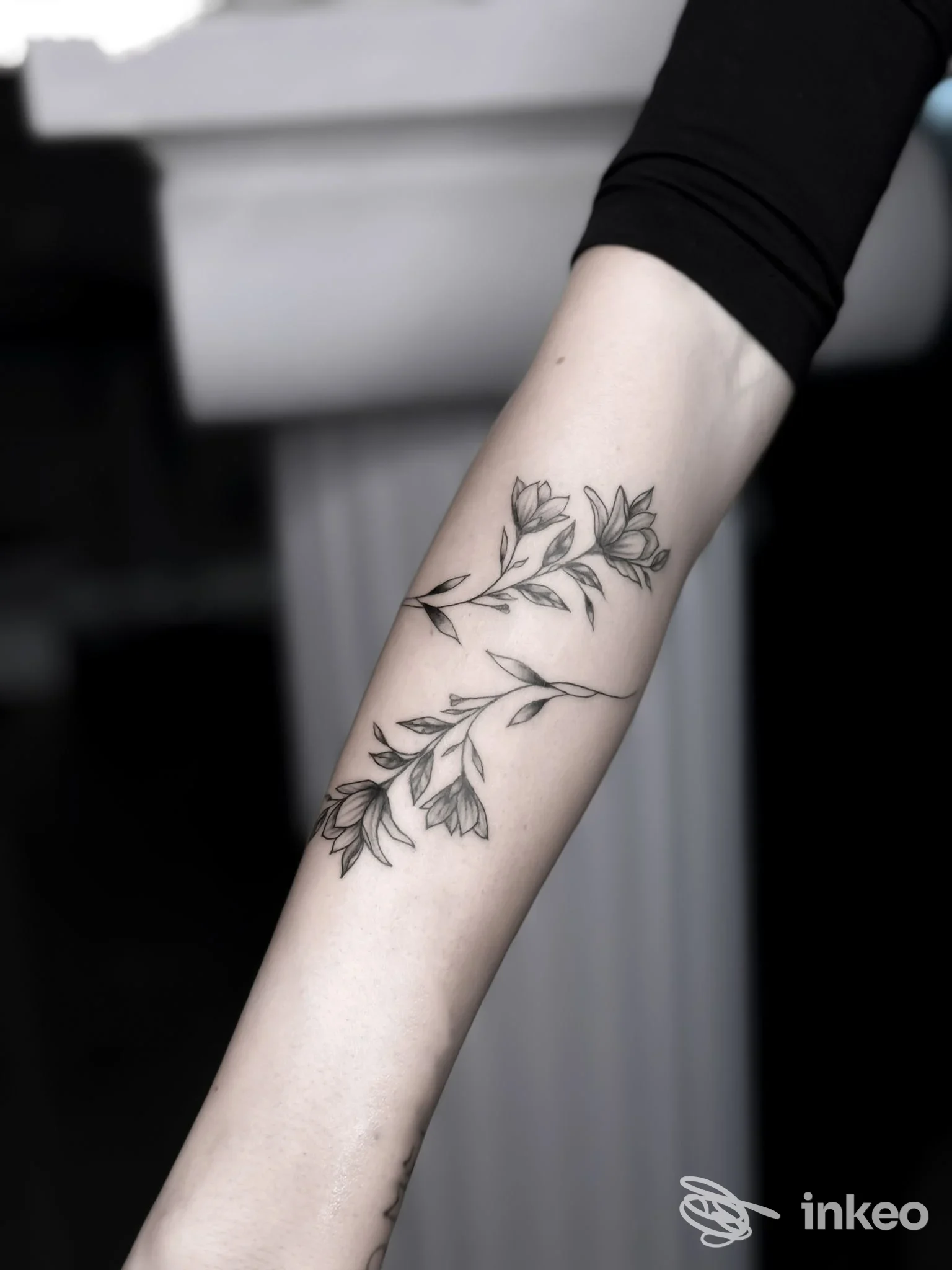 Avambraccio con due rami floreali tatuati in nero, foto realizzata per Pigmento Dermo Studio a Torino.