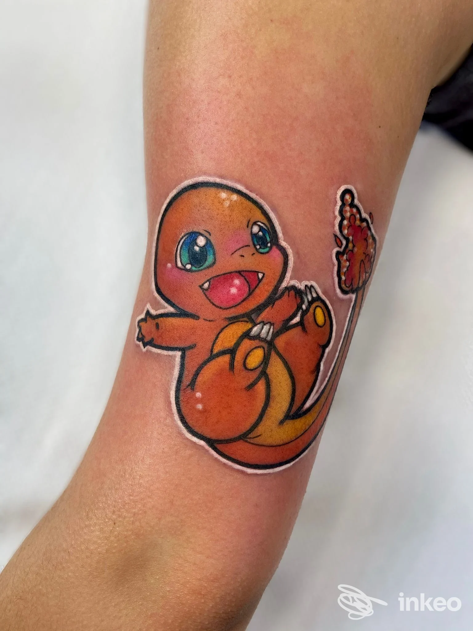 Tatuaggio colorato di Charmander sull'avambraccio interno, foto inviata da Greens Avenue Montevarchi Tattoo & Piercing, Montevarchi.