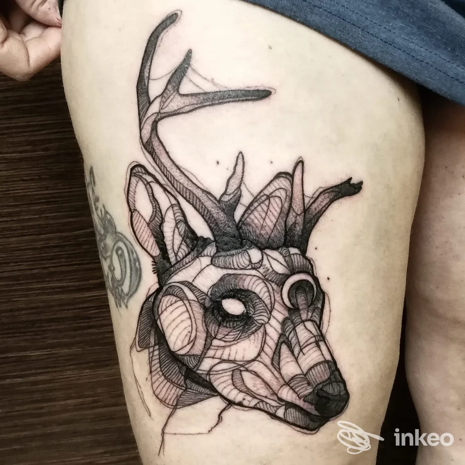 Tatuaggio testa di cervo in stile geometrico sulla coscia, foto scattata in Mountain Tattoo Studio, Feltre.