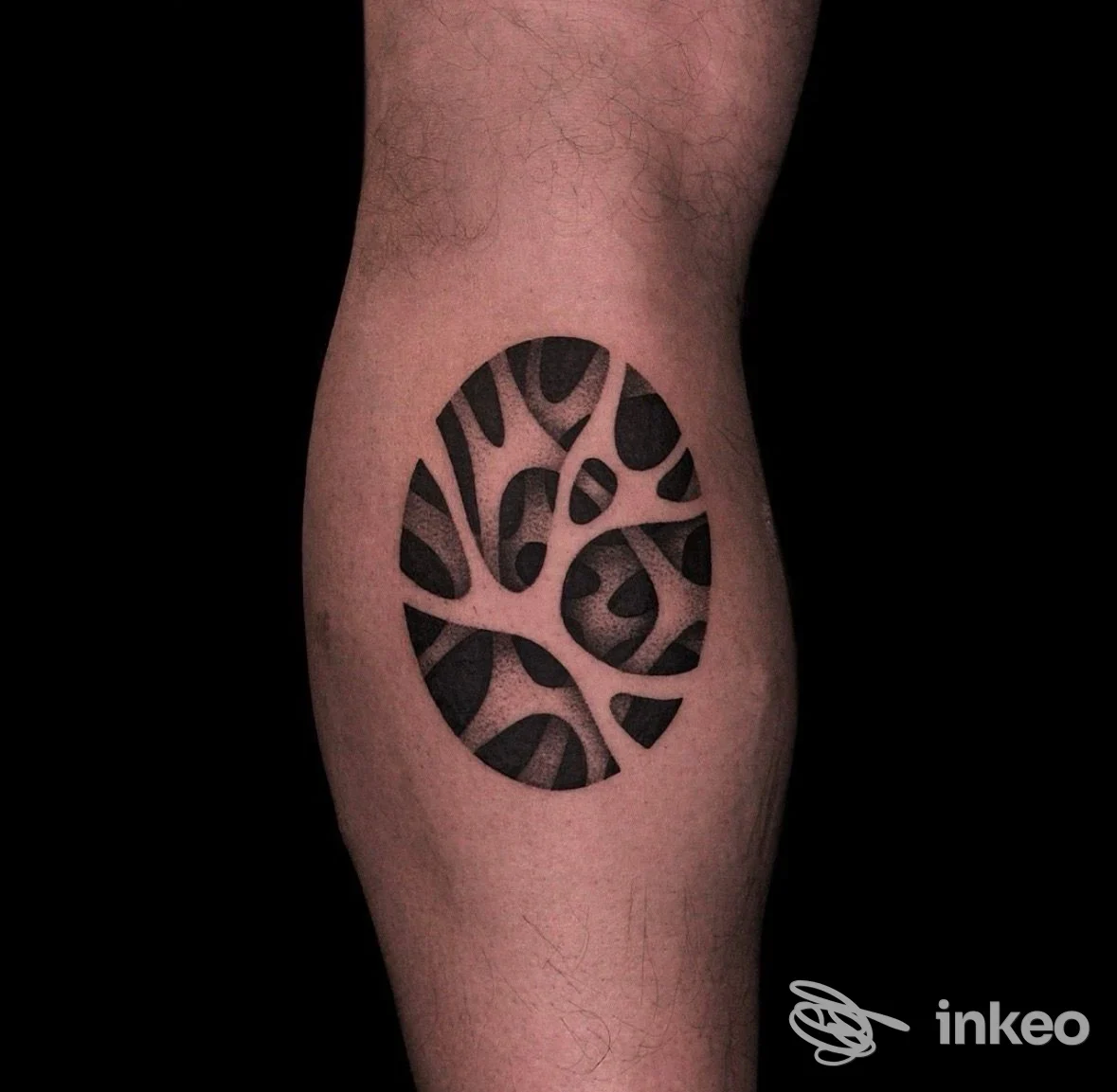 Tatuaggio blackwork a spazi negativi su polpaccio, foto dallo studio 61121 Tattoo Studio a Pesaro.