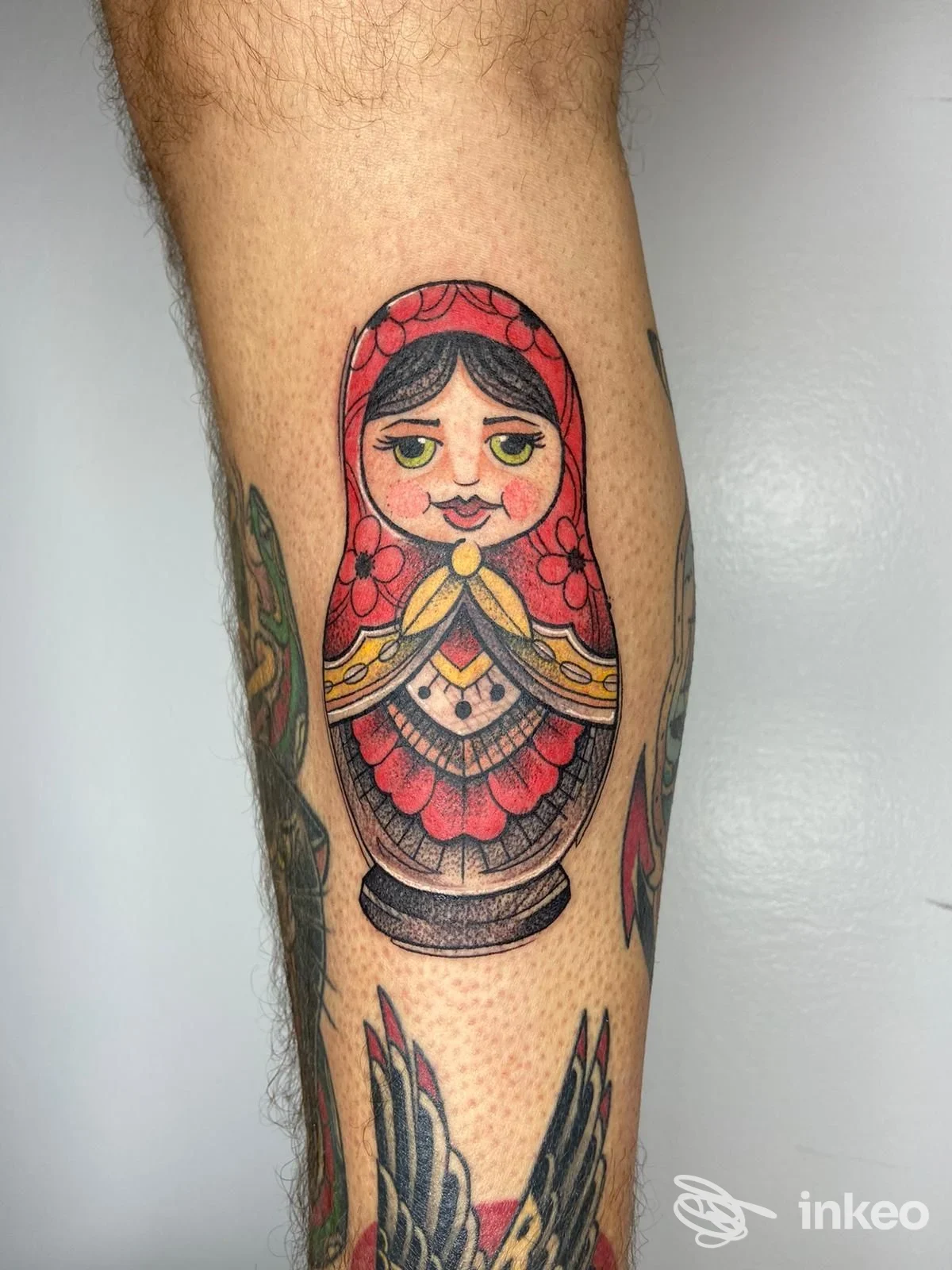 Tatuaggio colorato a tema matrioska sul polpaccio, dettagli lineari e ombreggiature nette; foto inviata da Skiri Art Tattoo a Chiaravalle.