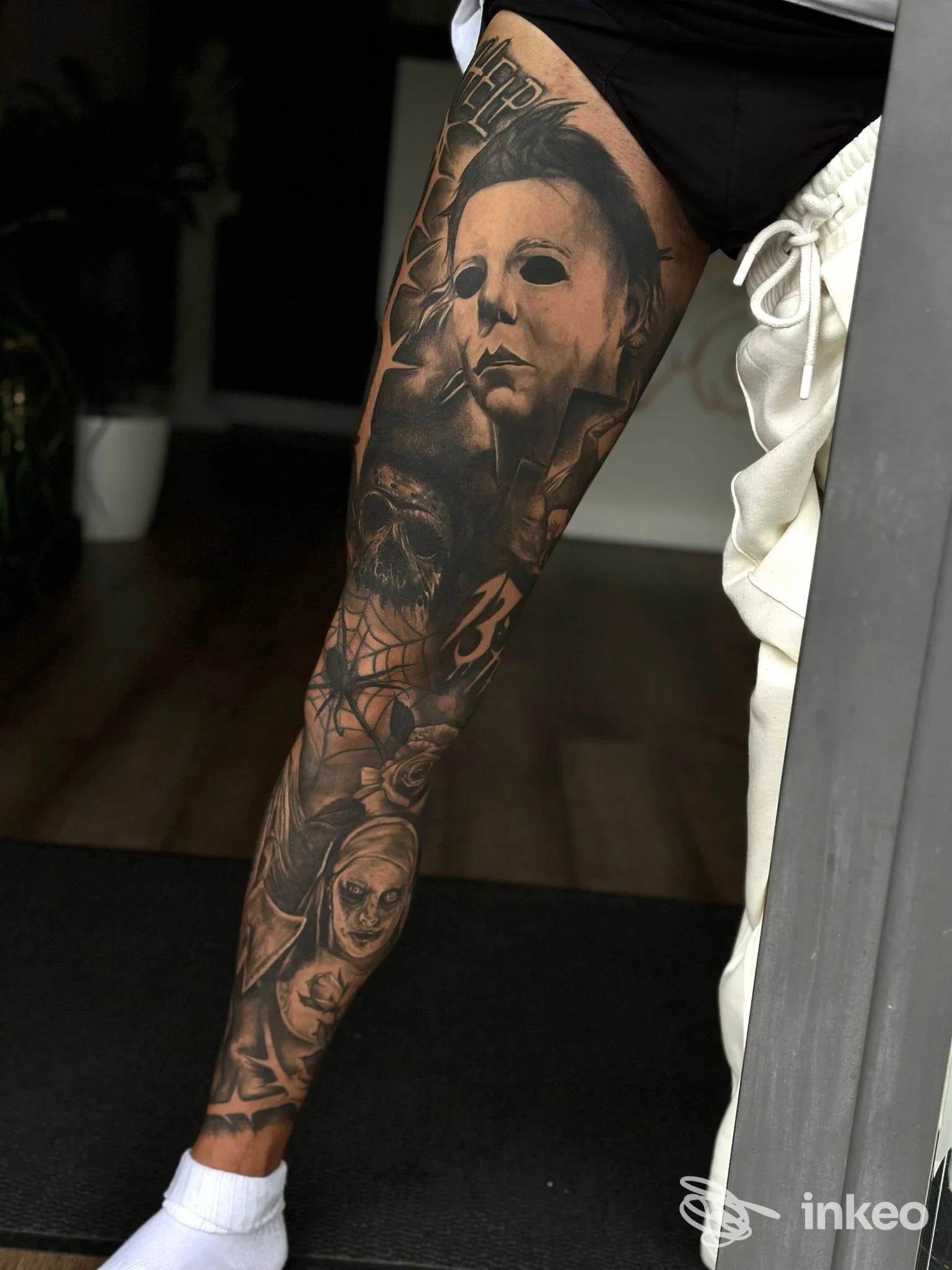 Gamba tatuata in stile black & grey con ritratti e motivi oscuri, foto fornita da Acanthus Tattoo Studio, Isernia.