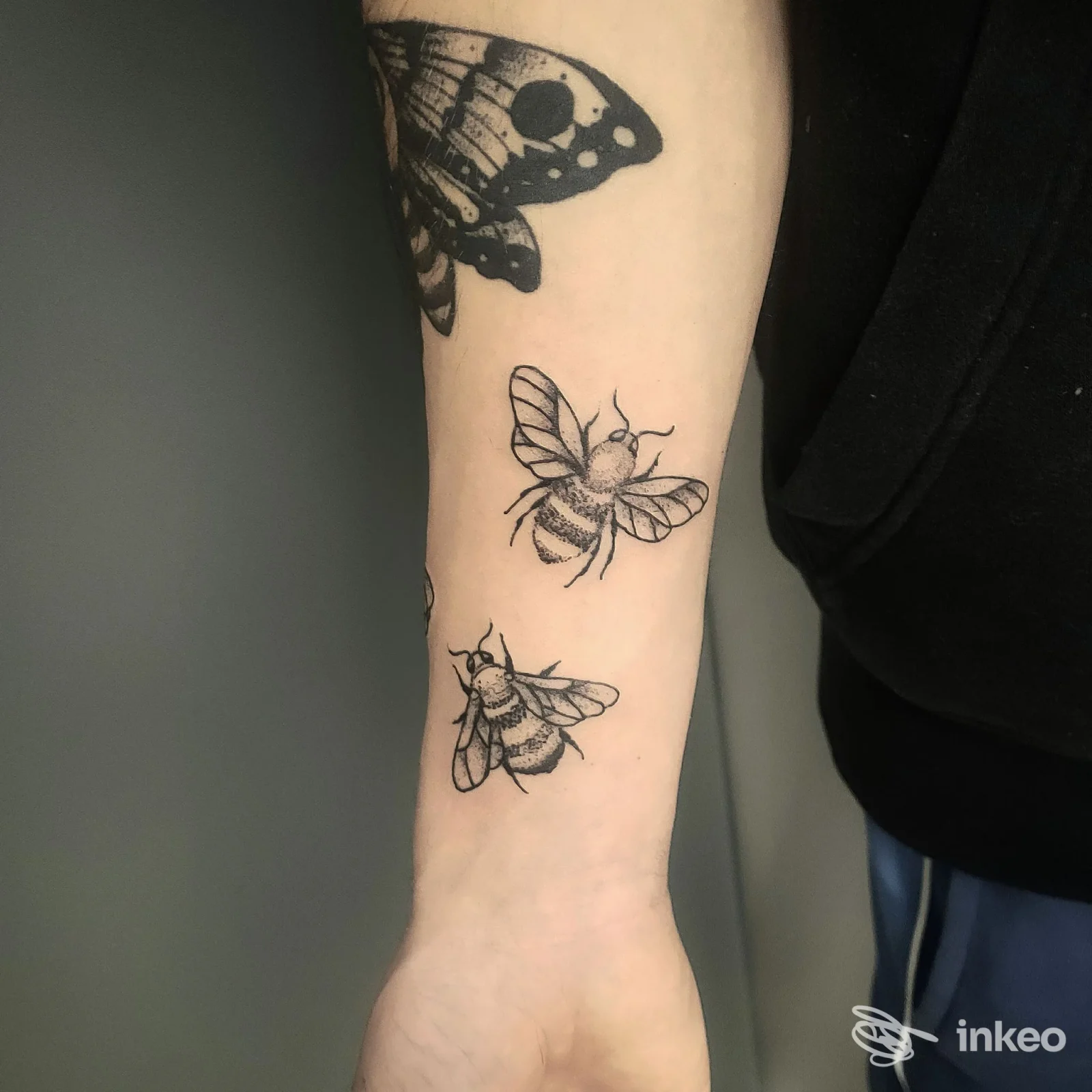 Due piccoli tatuaggi a forma di ape sull'avambraccio, con parte di una farfalla vicino al gomito. Tattoo Studio Steve, Domodossola.