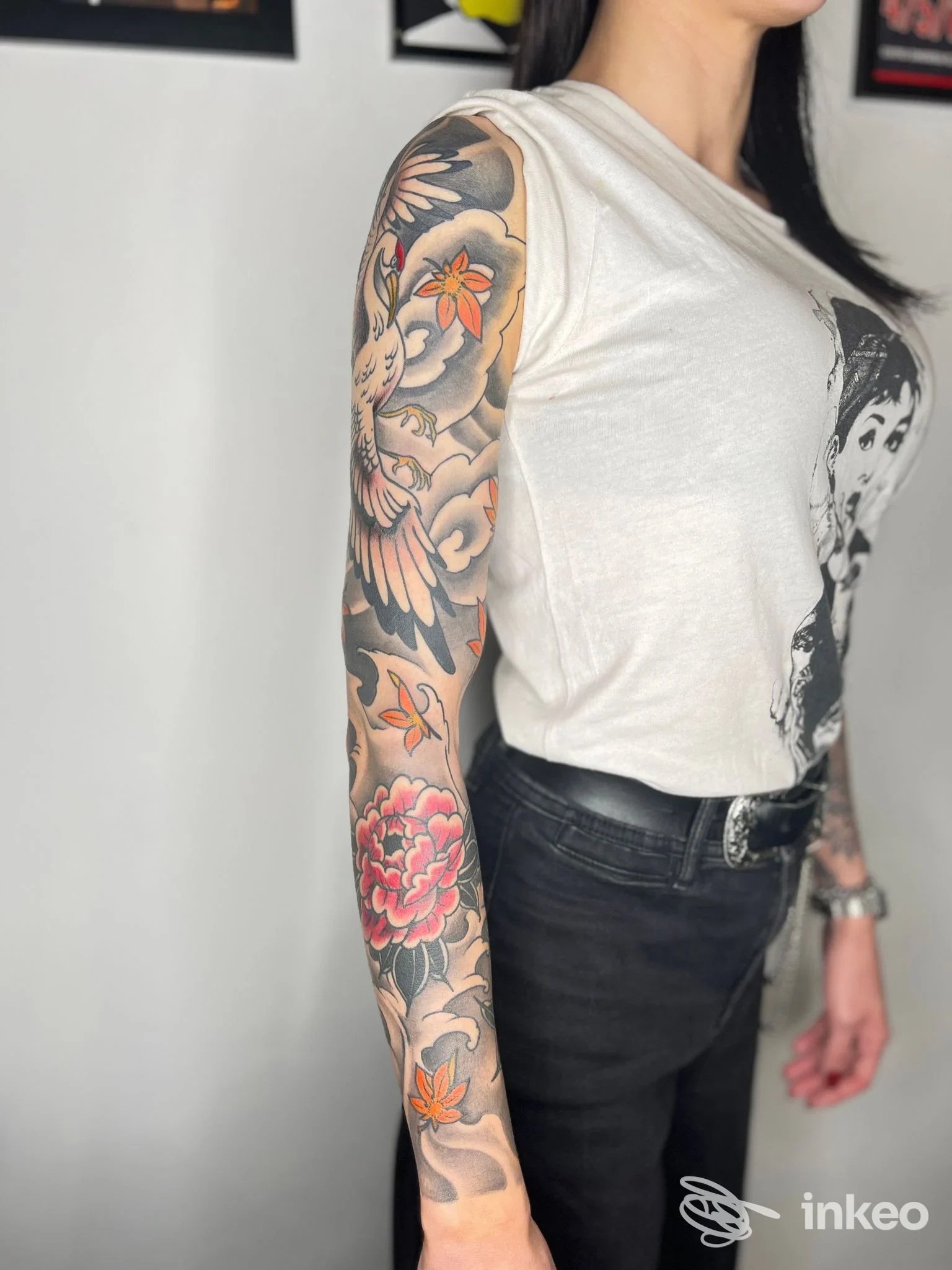 Manica tatuata su spalla e avambraccio con motivi floreali e uccello, foto fornita da Wild Art Tattoo Studio, Torino.