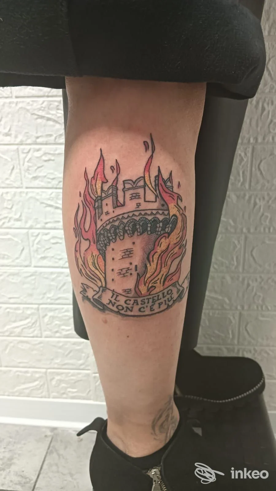 Tatuaggio a torre fiammeggiante sul polpaccio sinistro, fotografia inviata da RI.O.TATTOO STUDIO, Romano Canavese.