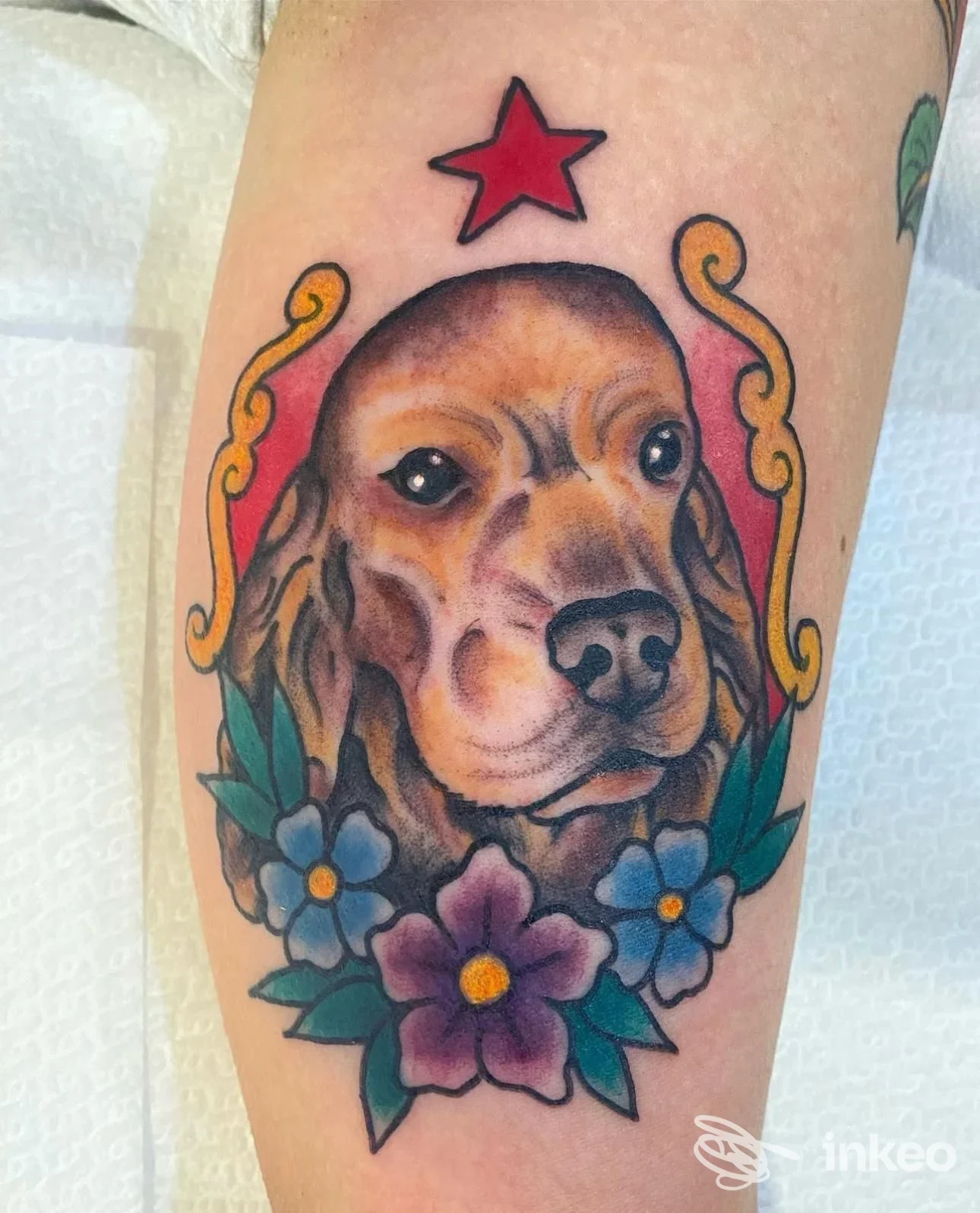 Tatuaggio ritratto di cane con fiori e stella sul polpaccio, realizzato da Hell Diver Tattoo Studio, Lecce.