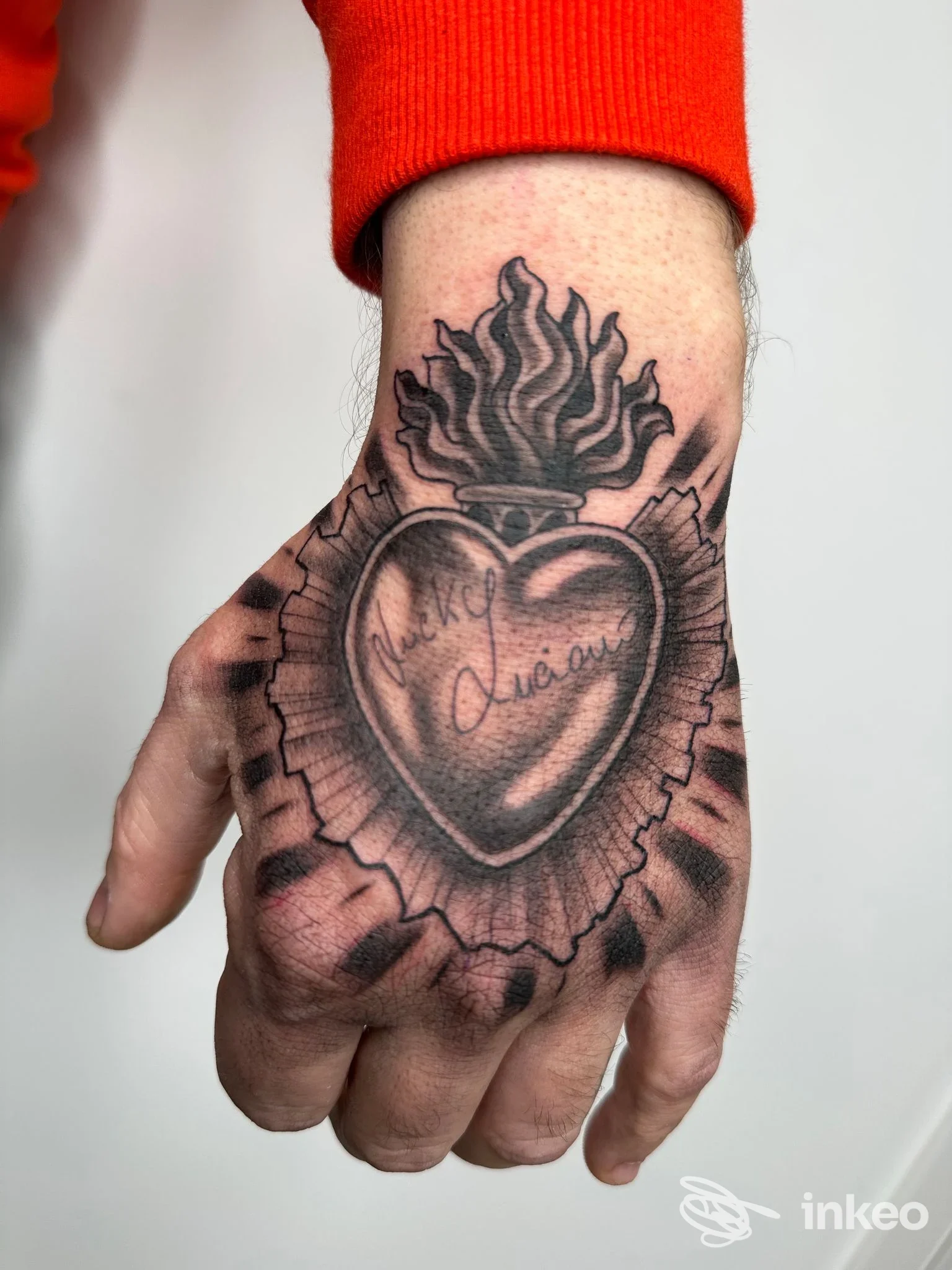 Tatuaggio a cuore sacro in bianco e nero sul dorso della mano, Mr FedeLine Tattoo studio, Lecce.