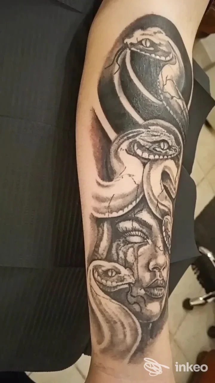 Tatuaggio black & grey di volti e serpenti sull'avambraccio, foto per ZIAPÁ TATTOO SHOP a Locorotondo.