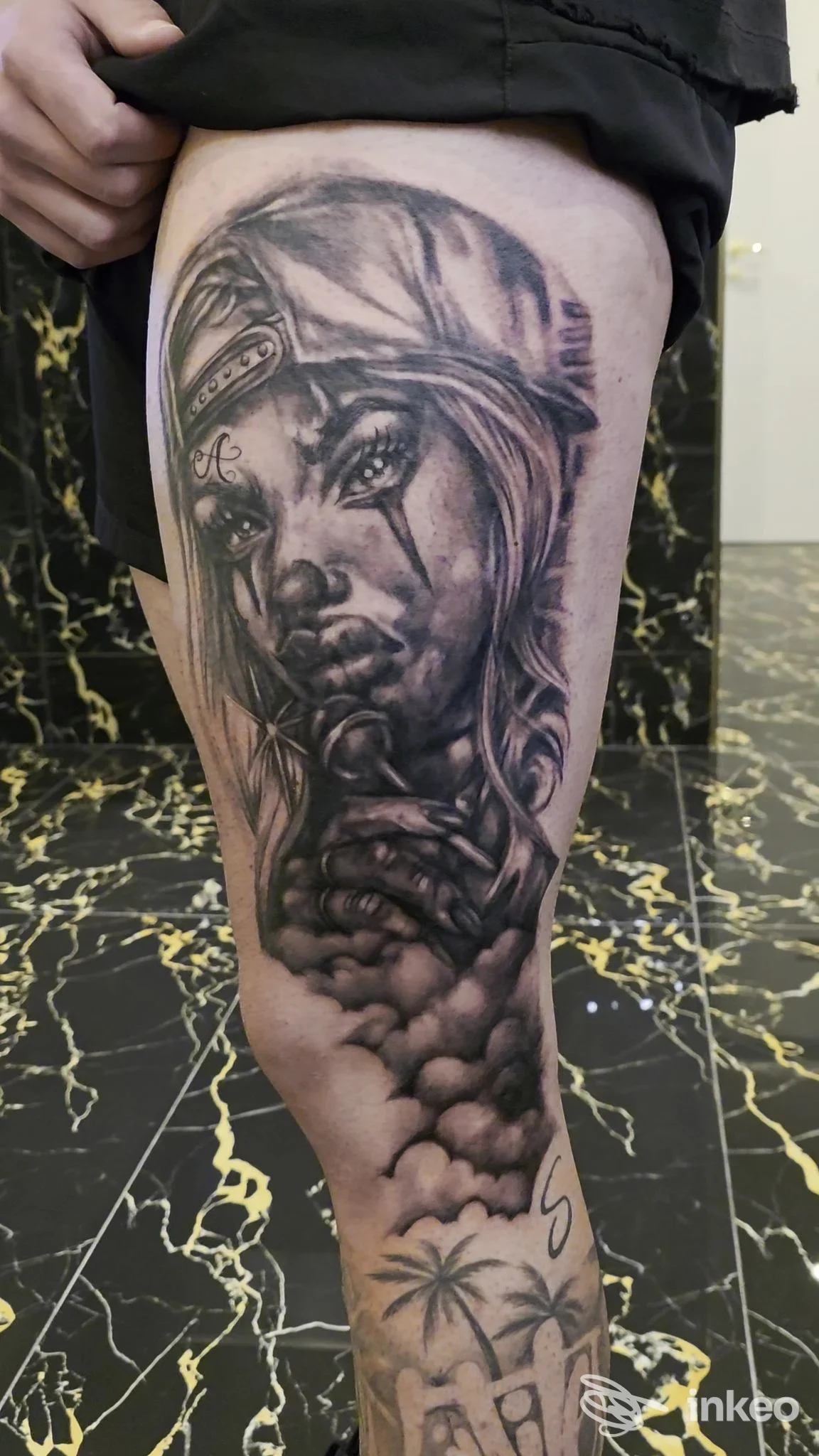 Tatuaggio realistico in bianco e nero di volto femminile sulla coscia, eseguito da INKIOSTRO studio tatuaggi a Cagliari.