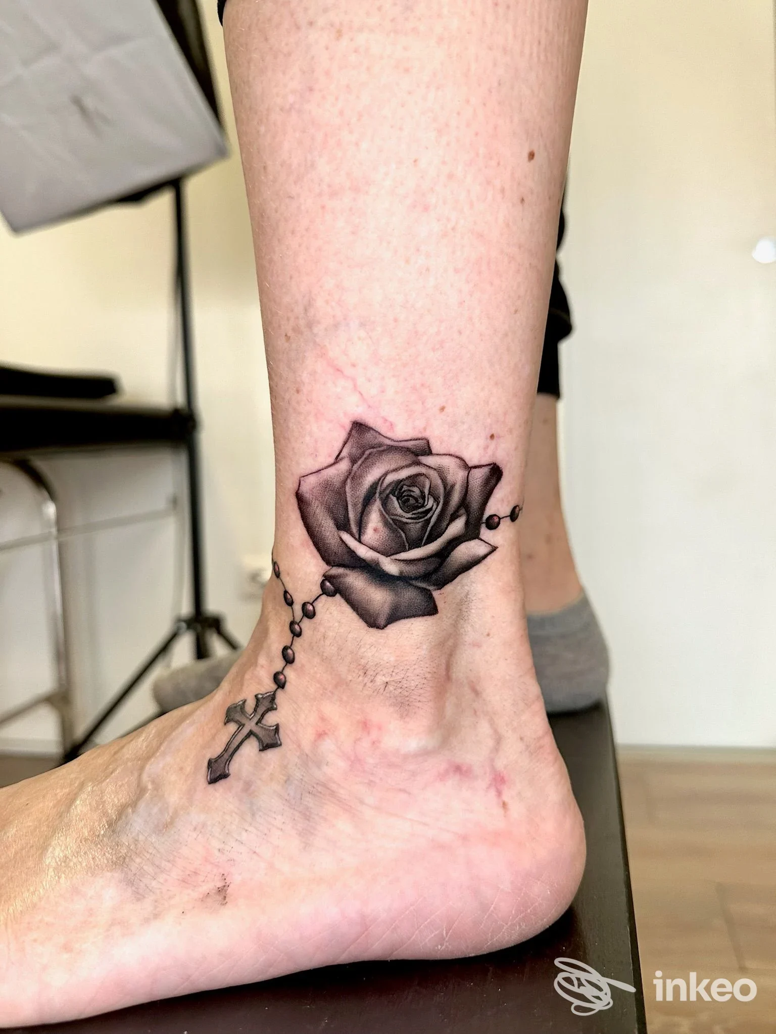 Tatuaggio black & grey di una rosa con rosario sulla caviglia e dorso del piede, Il Forestiero Tattoo, Cabras.
