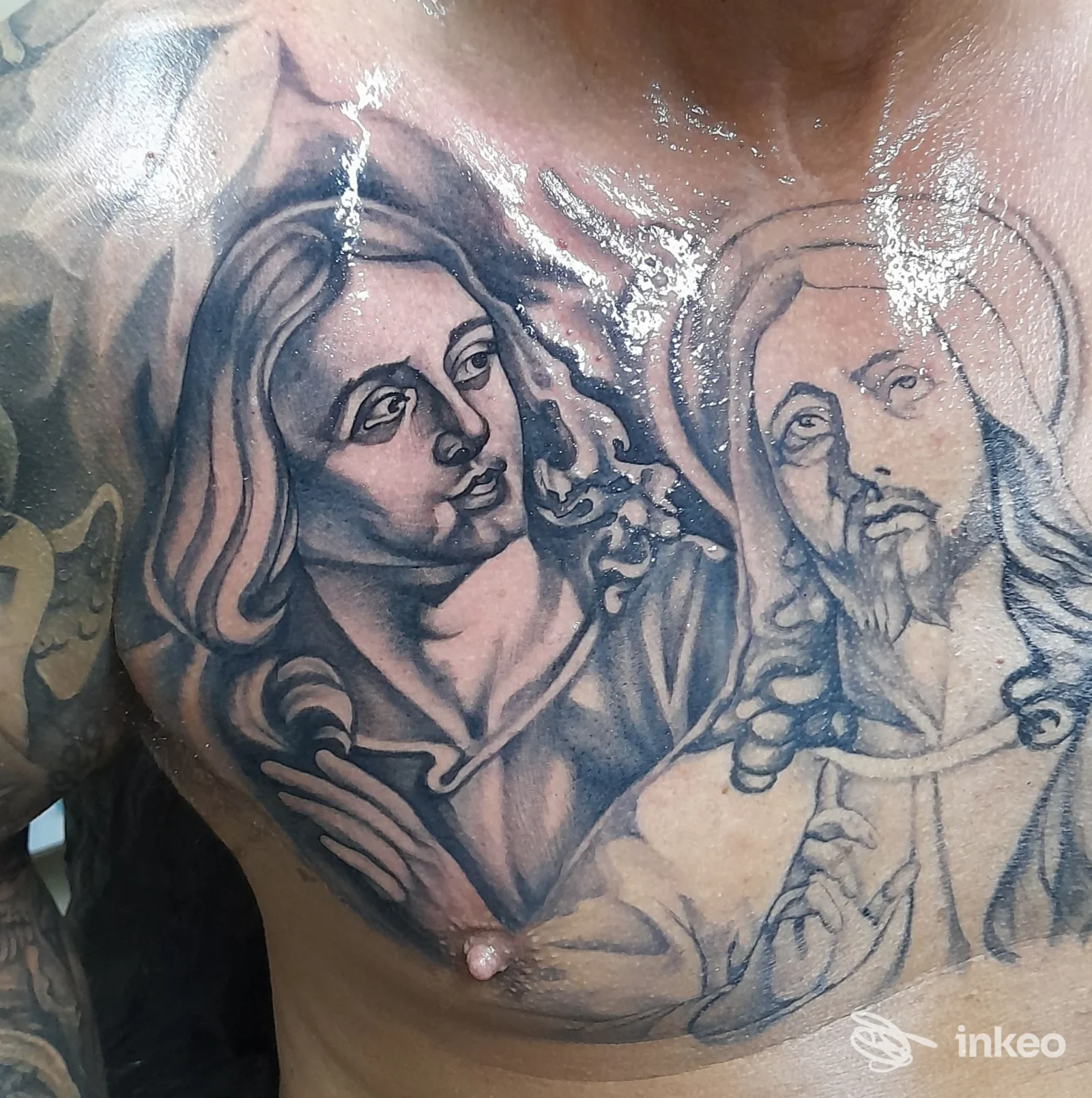 Foto del tatuaggio sul torace realizzato da G. P. Project S. R. L. studio tattoo a Cefalù, grandi figure religiose in bianco e nero.