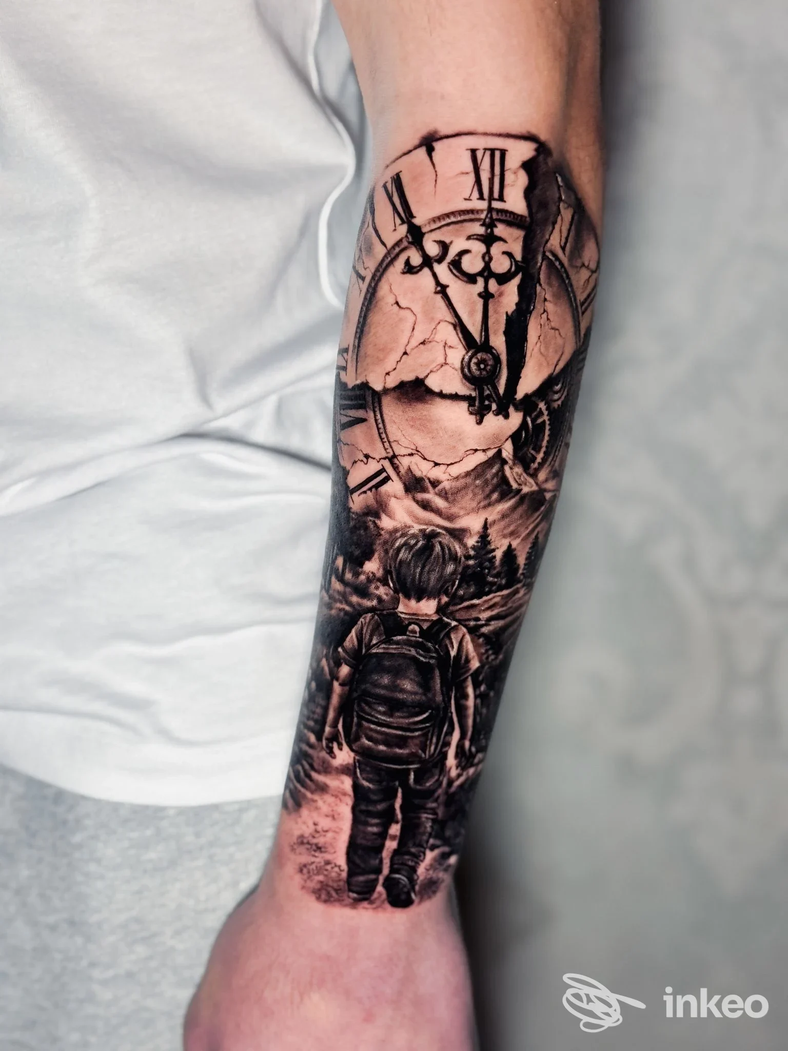 Tatuaggio in bianco e nero su avambraccio con orologio rotto e bambino che cammina, foto per Ink Life Tattoo Studio, Floridia.