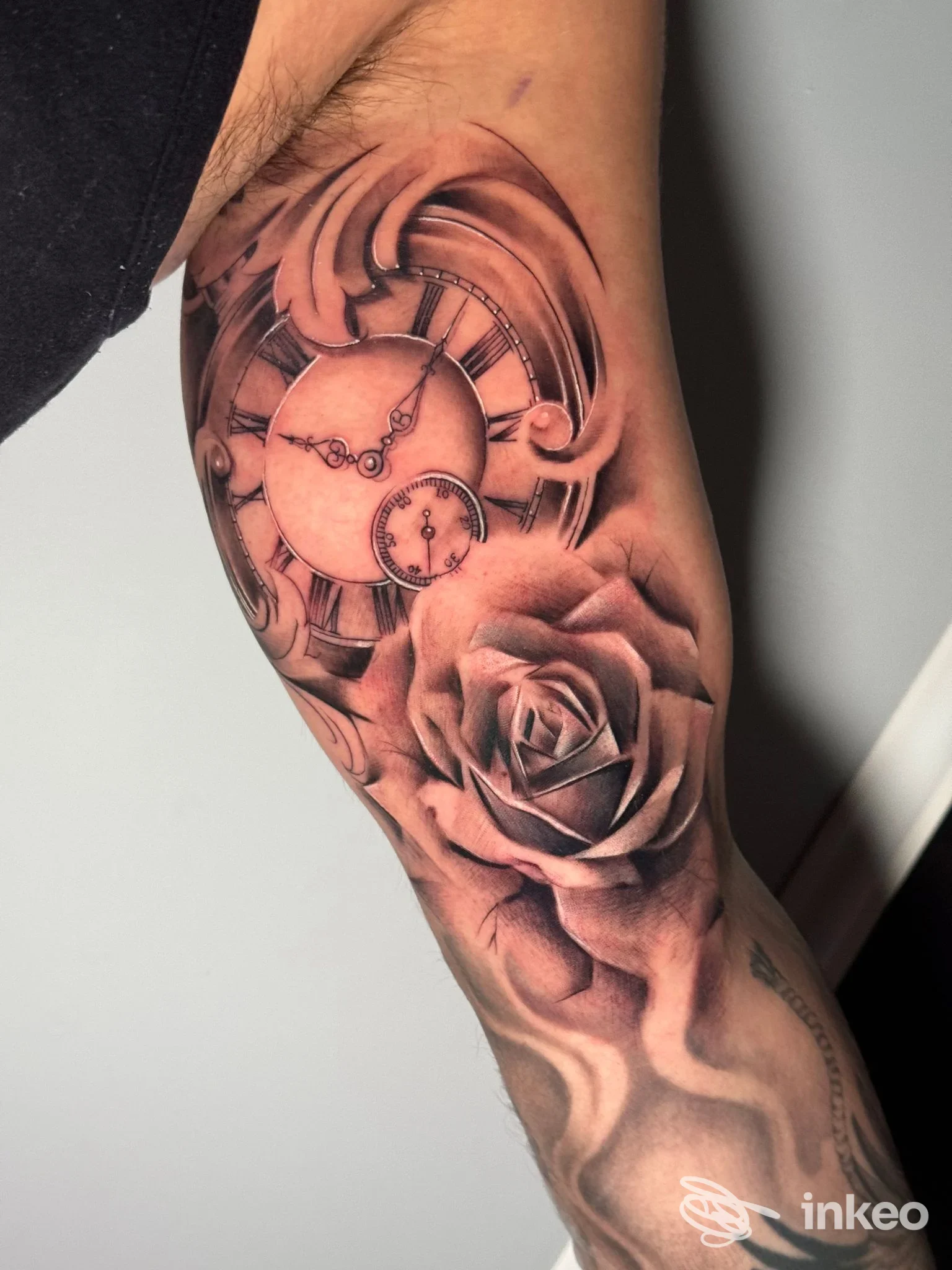Tatuaggio realistico raffigurante un orologio da tasca e una rosa in bianco e nero sul braccio, eseguito da Kame House Tattoo Studio a Palermo.