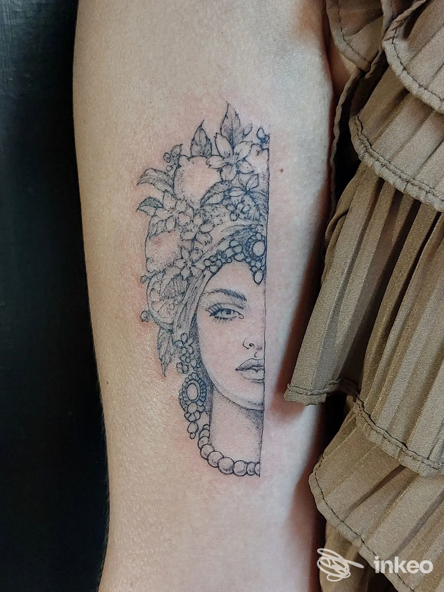 Tatuaggio su avambraccio interno: mezzo volto femminile con fiori, MEDUSA SHOP TATTOO PARLOUR, Palermo.