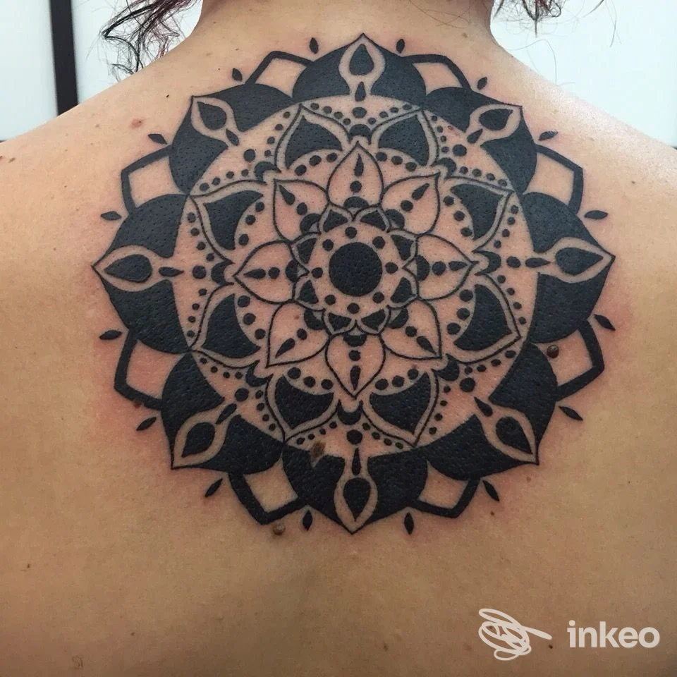 Ampio tatuaggio mandala nero sul dorso superiore, lavoro eseguito da Tattoo Daniele Cirolli a Giarre; linee nette e riempimenti solidi.