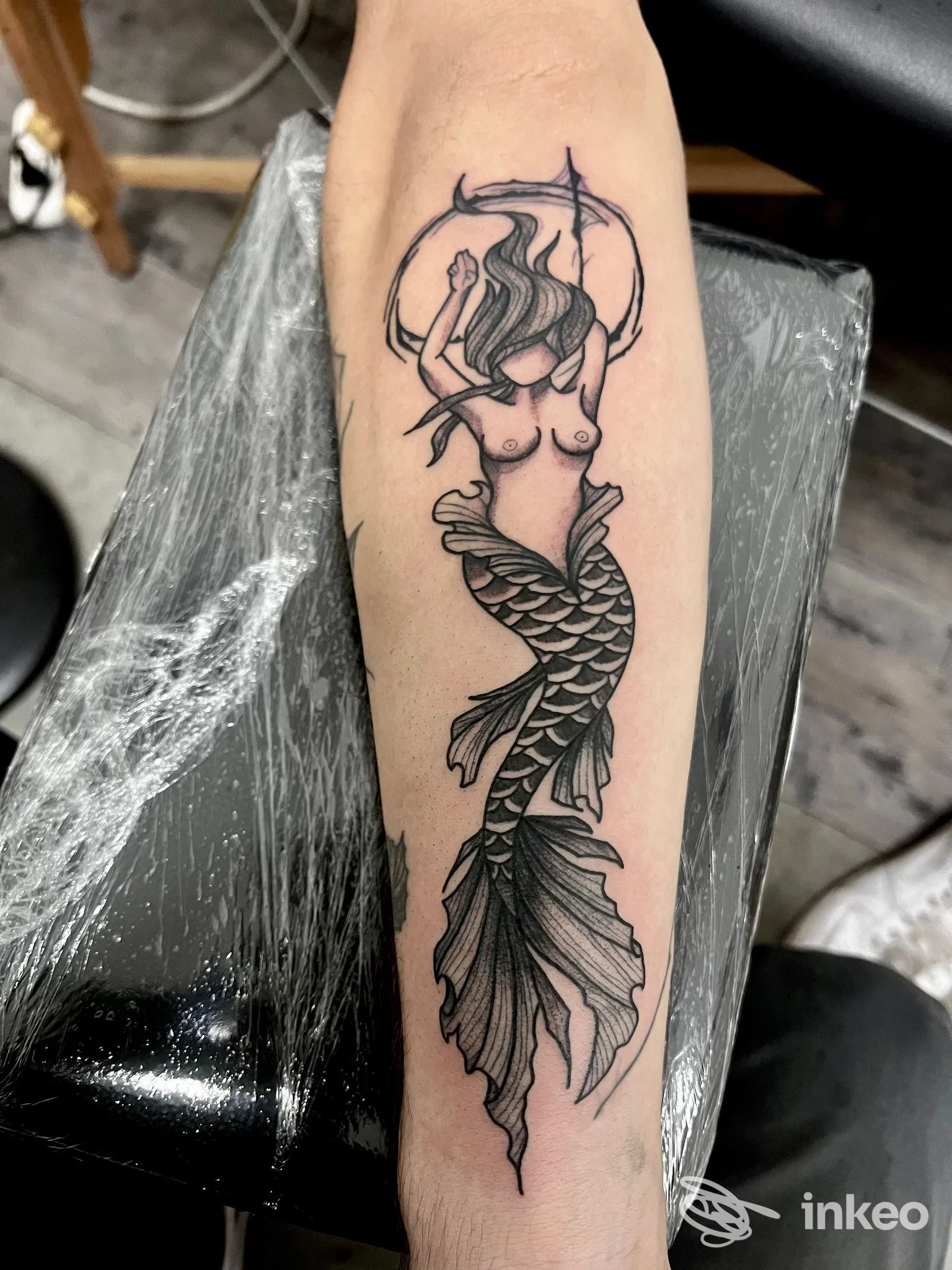 Tatuaggio a inchiostro nero di una sirena sull'avambraccio, Augusta Ink Tattoo Studio, Augusta.