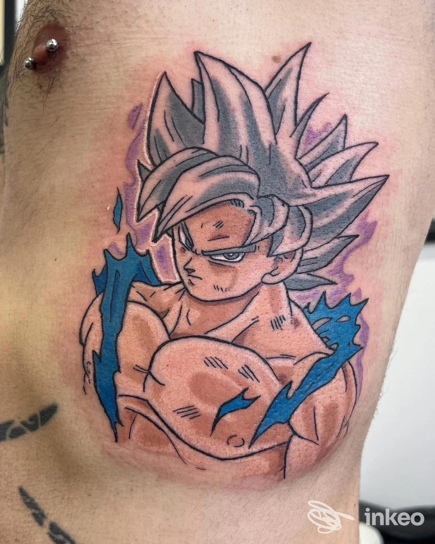 Tatuaggio a tema anime sul torace vicino al capezzolo sinistro, foto dallo studio Old Boys Electric Tattoo a Livorno.