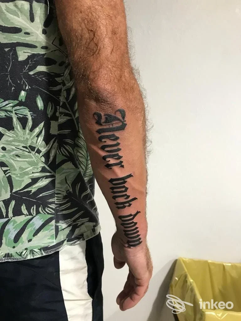 Avambraccio con tatuaggio in lettere gotiche nere, foto inviata dallo studio SHADOW Ink tattoo - LOCARINI a Cascina.