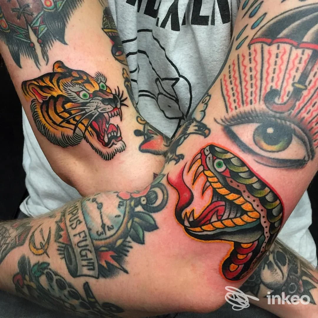 Dettaglio di tatuaggi tradizionali colorati (tigre, serpente, occhio) su avambracci. Samuele Briganti - Bold Will Hold Tattoo, Firenze.