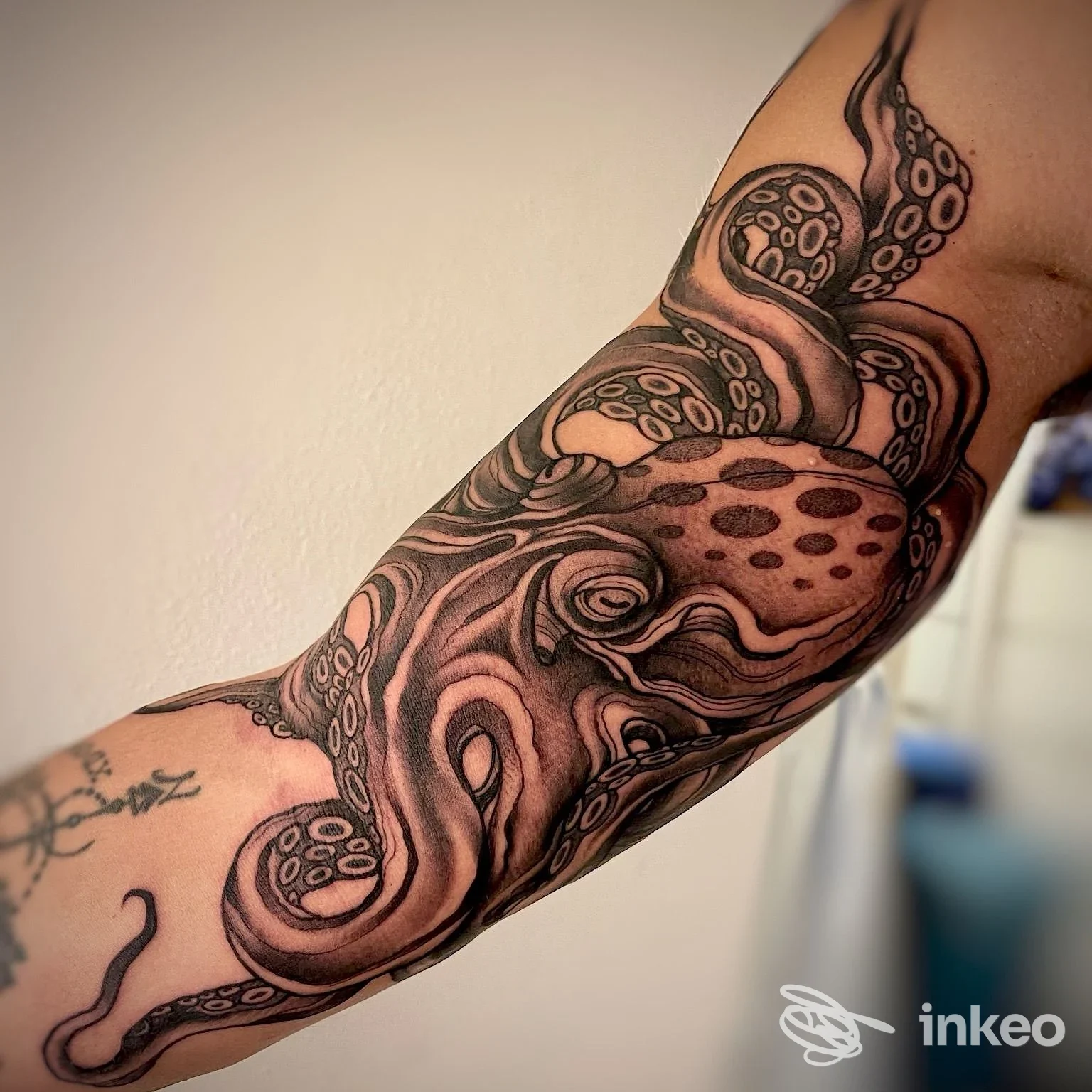 Braccio con tatuaggio a tema polpo in bianco e nero, dettaglio dell'avambraccio. Foto per The Black Belt Tattoo, Viareggio.