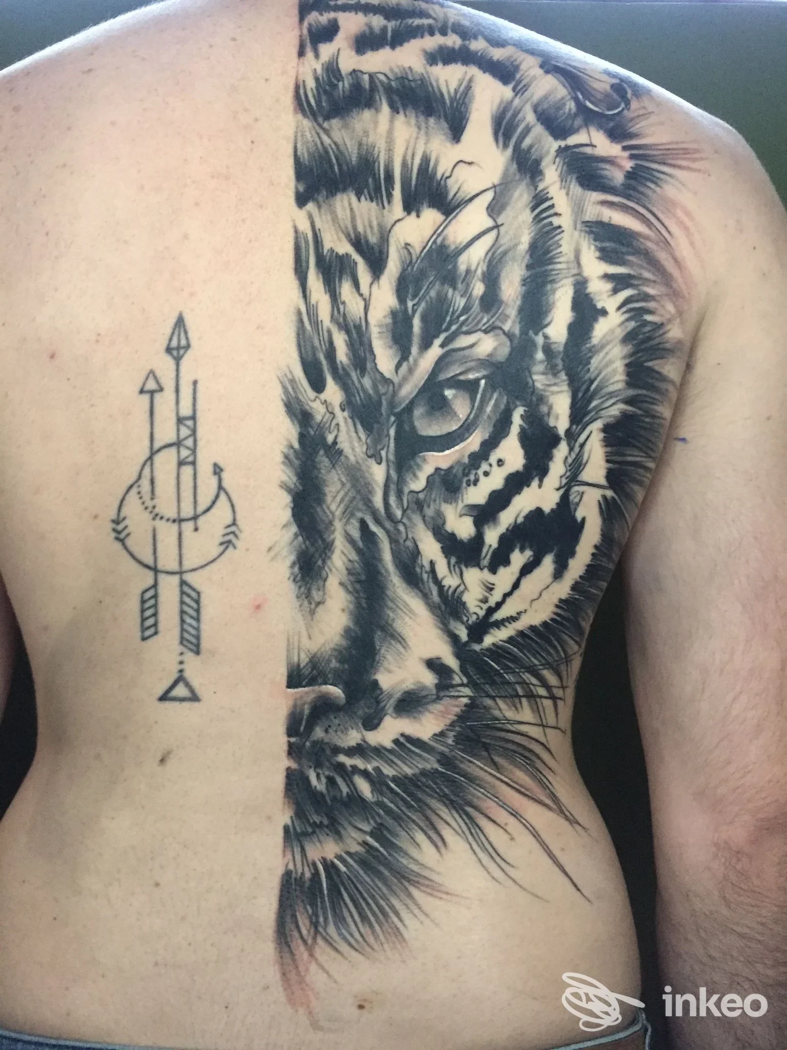 Mezza schiena con grande tatuaggio a mezzo volto di tigre in bianco e nero e un motivo geometrico, immagine fornita da Cotton Candy Tattoo, Tavarnuzze.