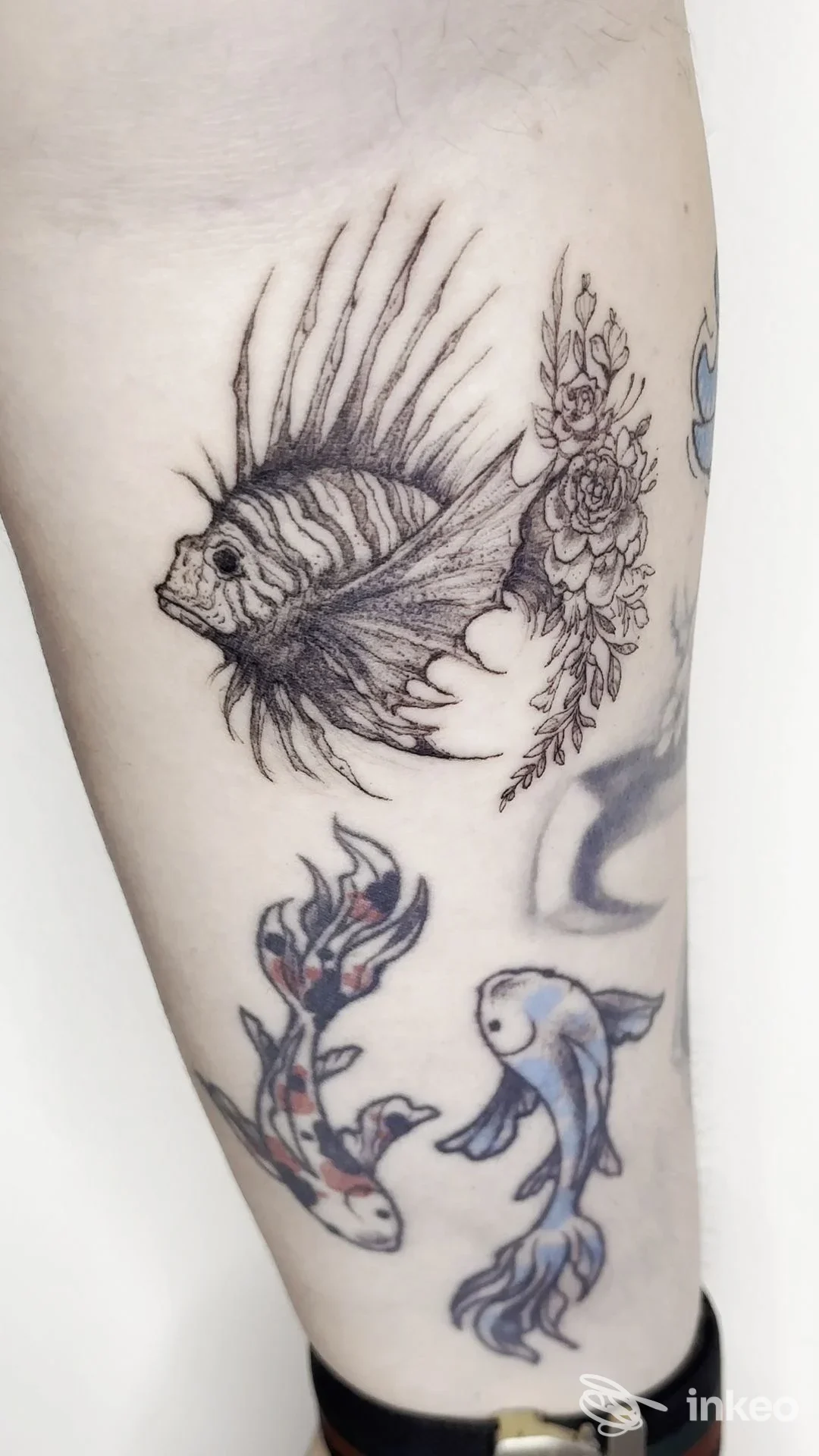 Tatuaggi su avambraccio con pesce stilizzato in linework e due carpe colorate — Alex Alvarez Tattoo Shop, Firenze.