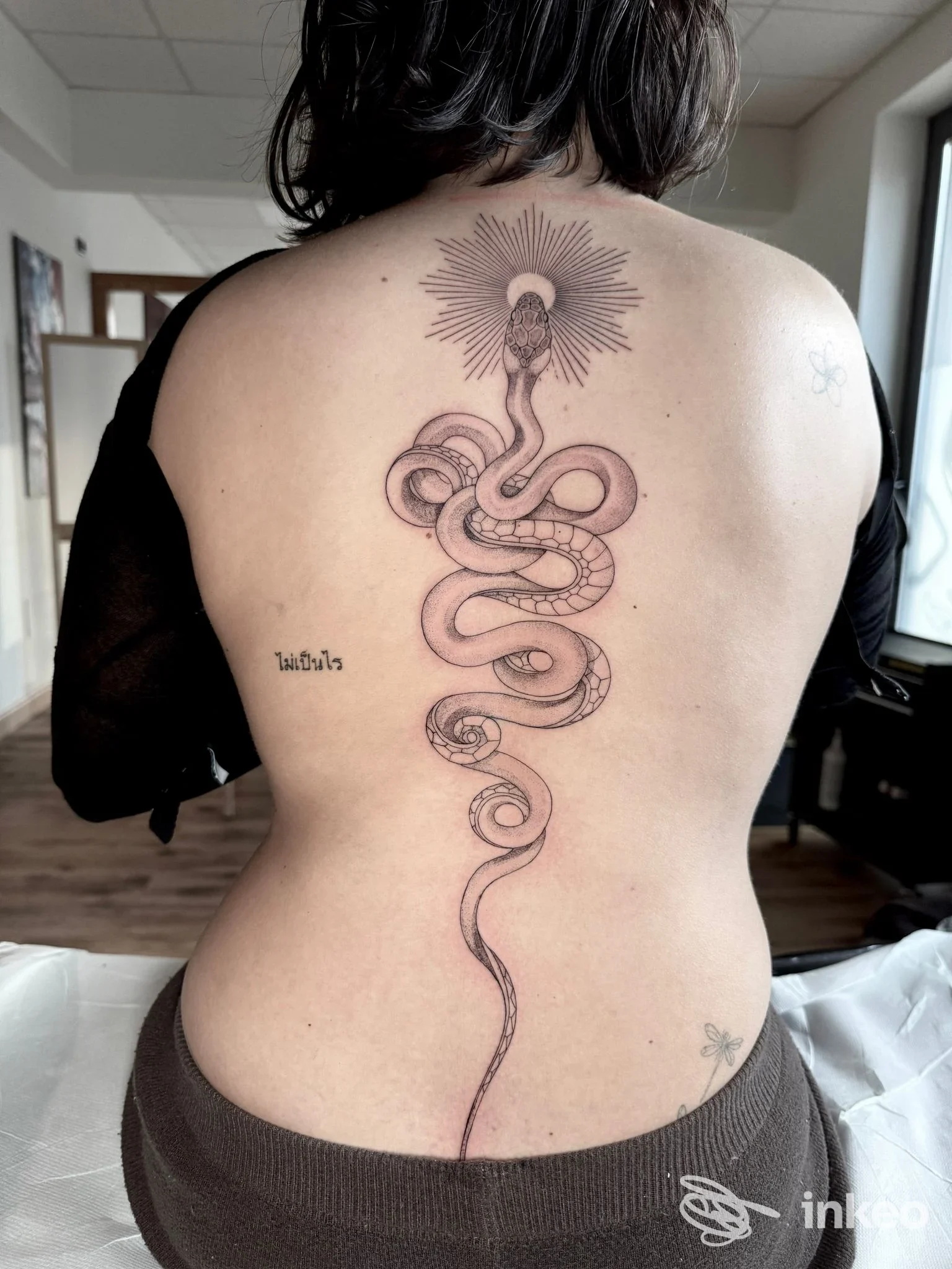Tatuaggio a serpente lungo la colonna vertebrale, foto di Inlè Tattoo Studio a Lucca.
