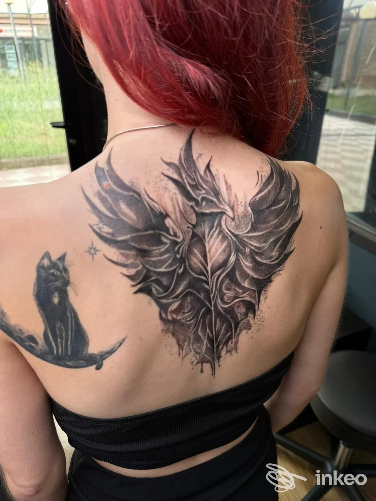 Grande tatuaggio nero-grigio sulla parte superiore della schiena di una cliente, Lateral Thinking Tattoo & Piercing, Grosseto.