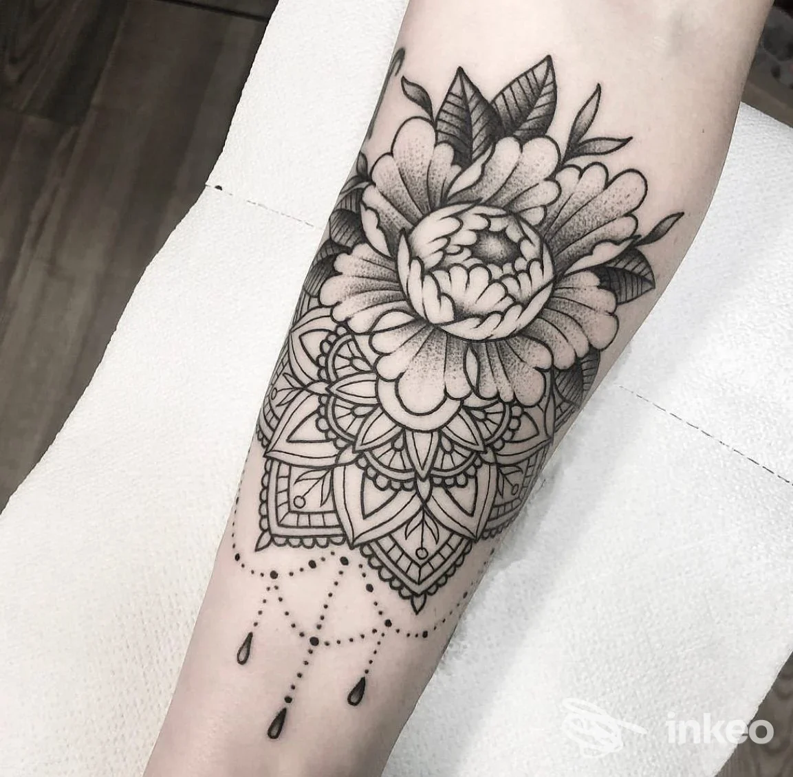 Tatuaggio floreale e mandala in nero sull'avambraccio, foto dello studio Tiger's Milk Tattooing a Forte dei Marmi.
