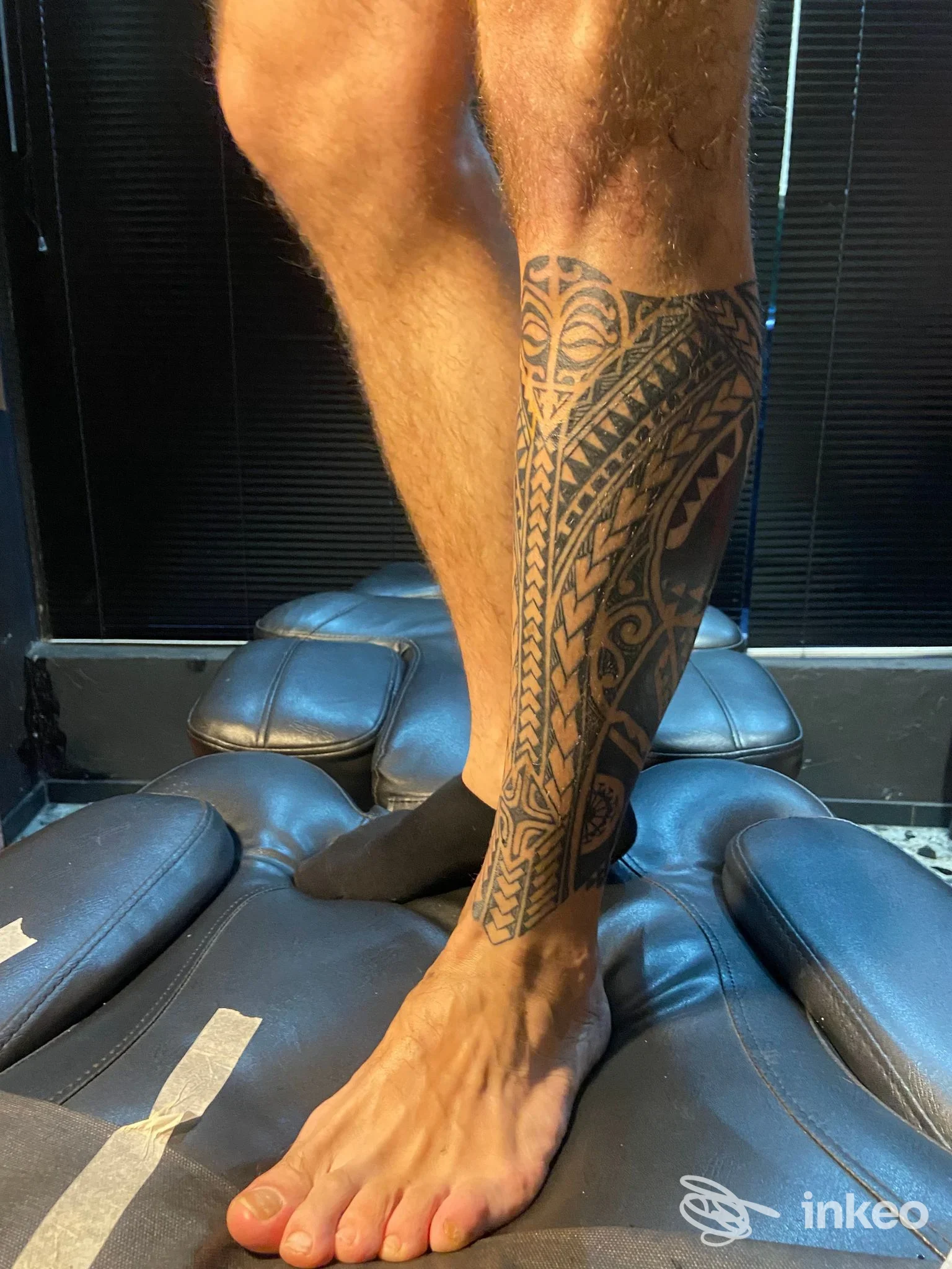 Tatuaggio in stile polinesiano che copre il polpaccio destro, fotografato su lettino del Tosho Tattoo Studio a Rovereto.