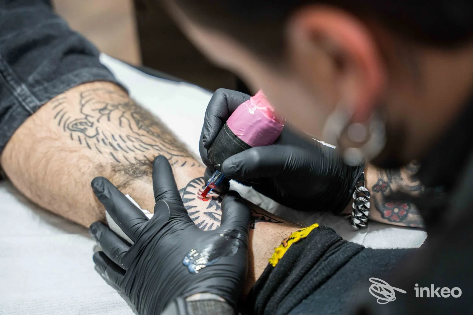 Tatuatore che inchiostra un disegno sull'avambraccio presso Erik Alba Classic Tattoo Studio, Foligno.
